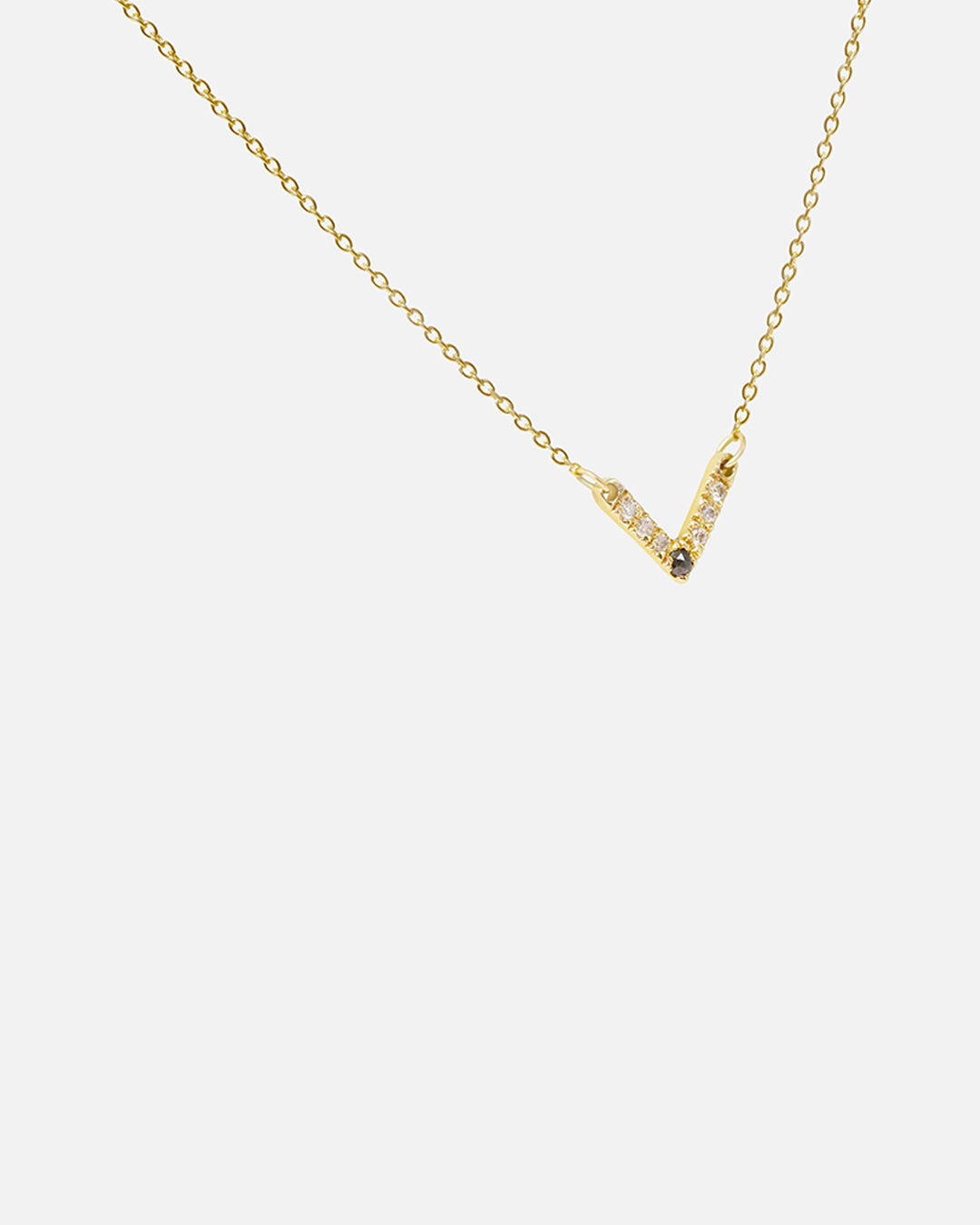 Side view of White and Black Diamond Pendant in 14k yellow gold