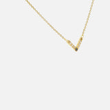 Side view of White and Black Diamond Pendant in 14k yellow gold