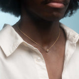 Model wears Skull Drop Down Pendant in 18k Red Gold