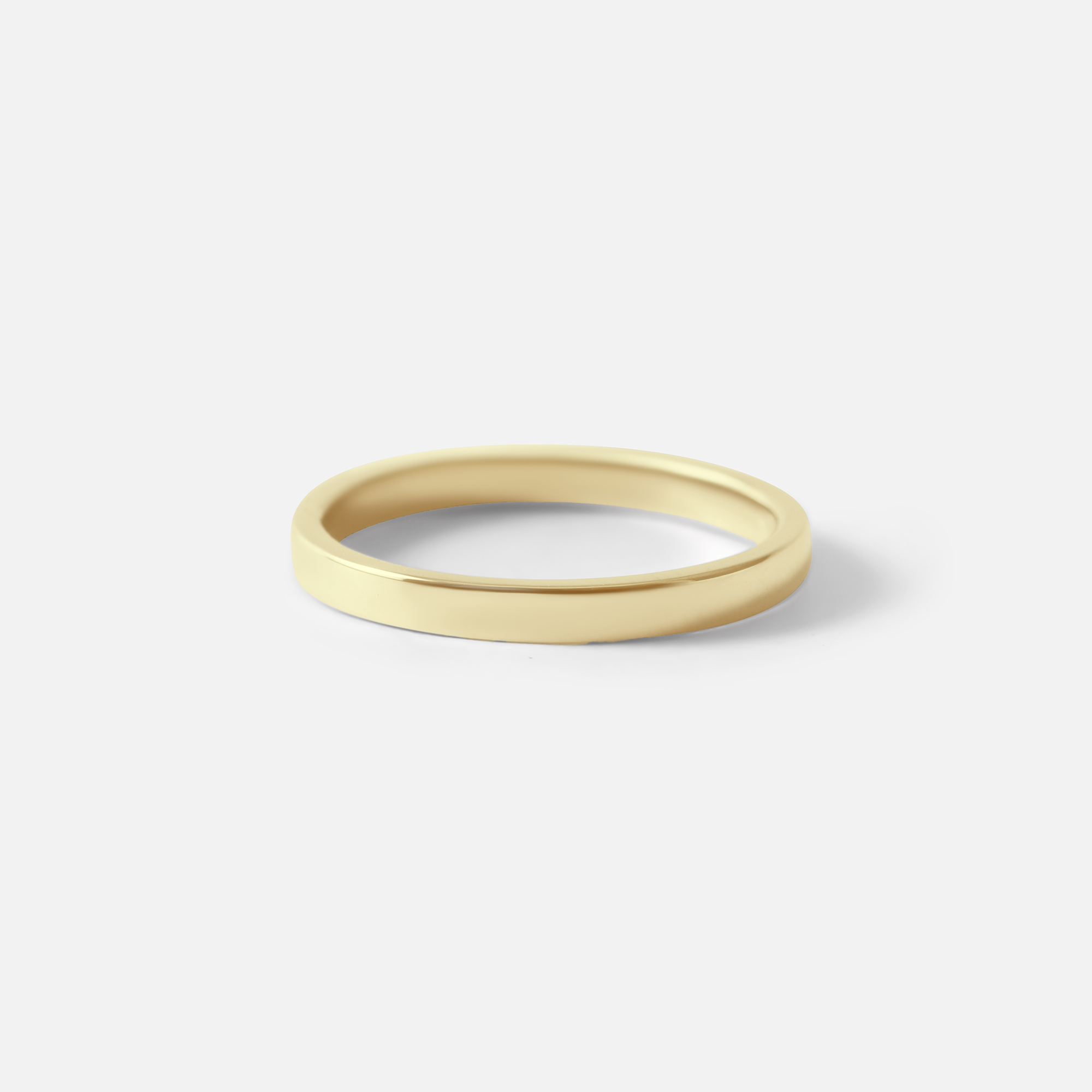 Angled view of Flat Band / 2mm Customizable By Hiroyo in 14k yellow gold