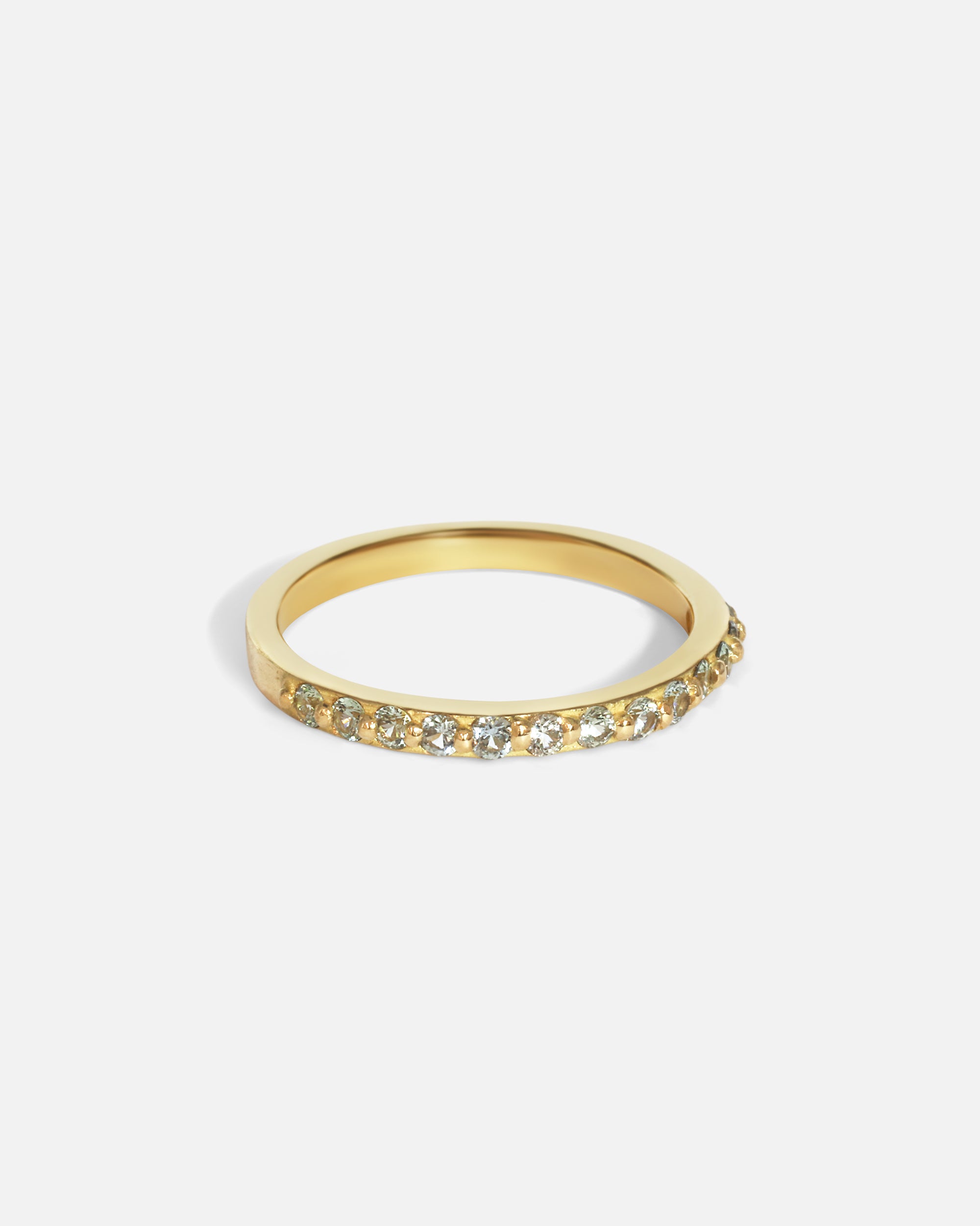 Side view of Dew 3mm / Blue Green Sapphire in 18k yellow gold by Hiroyo