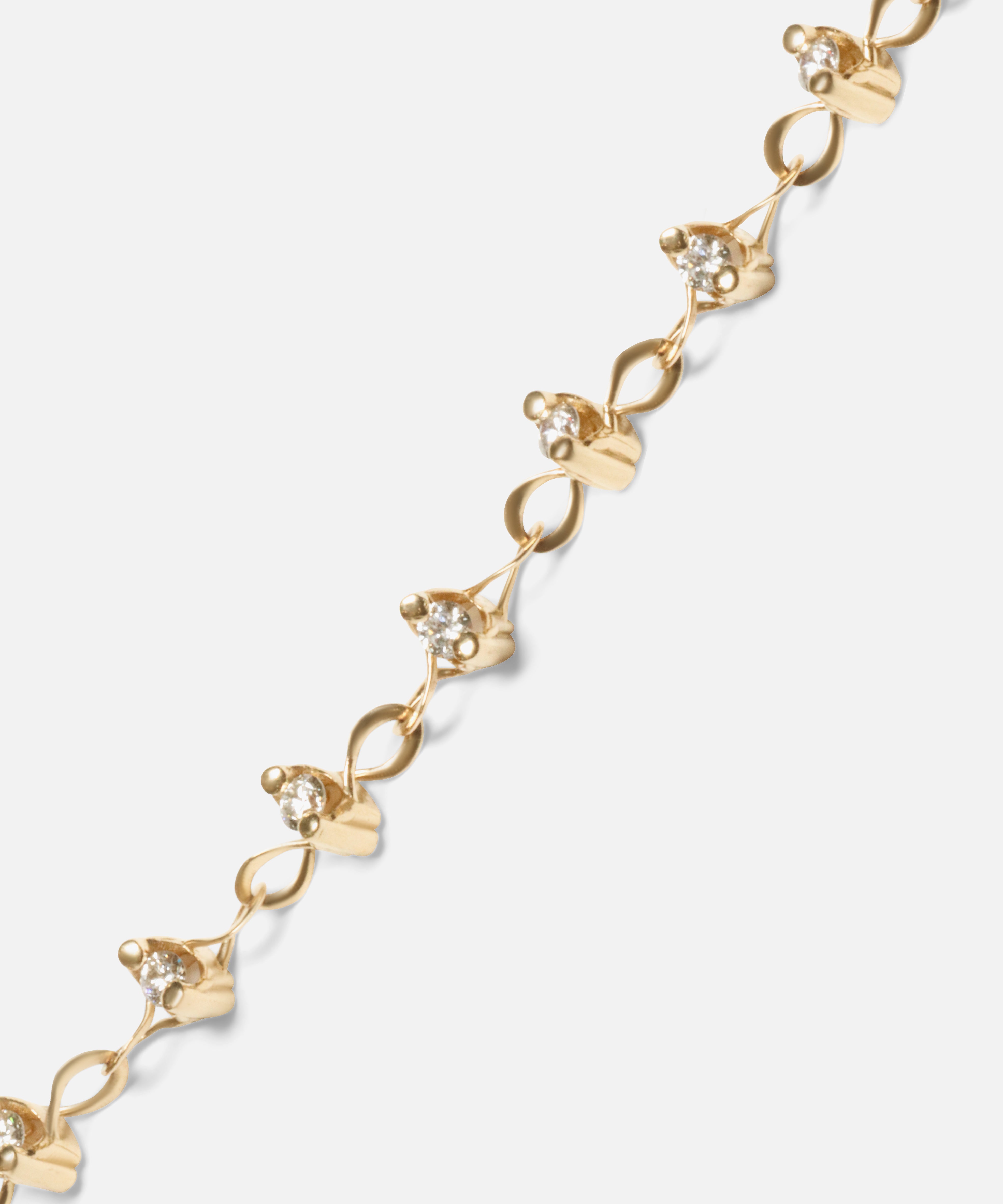Close up view of Locus Intermittendi Bracelet	in 14k yellow gold by Lucia B Marti