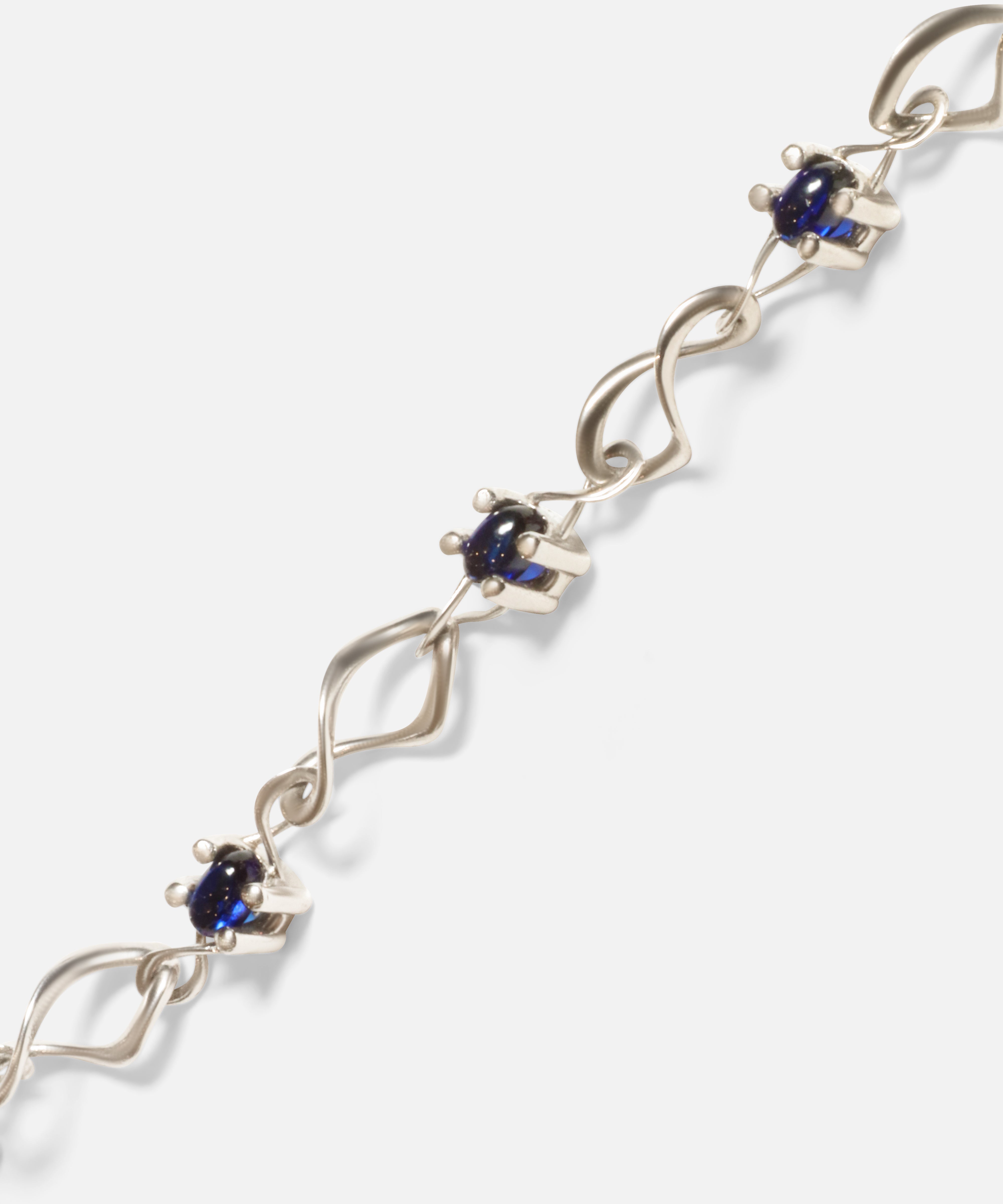 Close up view of Nucleus Intermittendi Bracelet / Sapphire in 14k white gold by Lucia B Marti