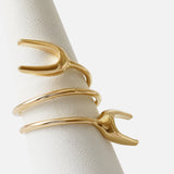 Angled view of Double X Ring By Lucia B Marti on stand