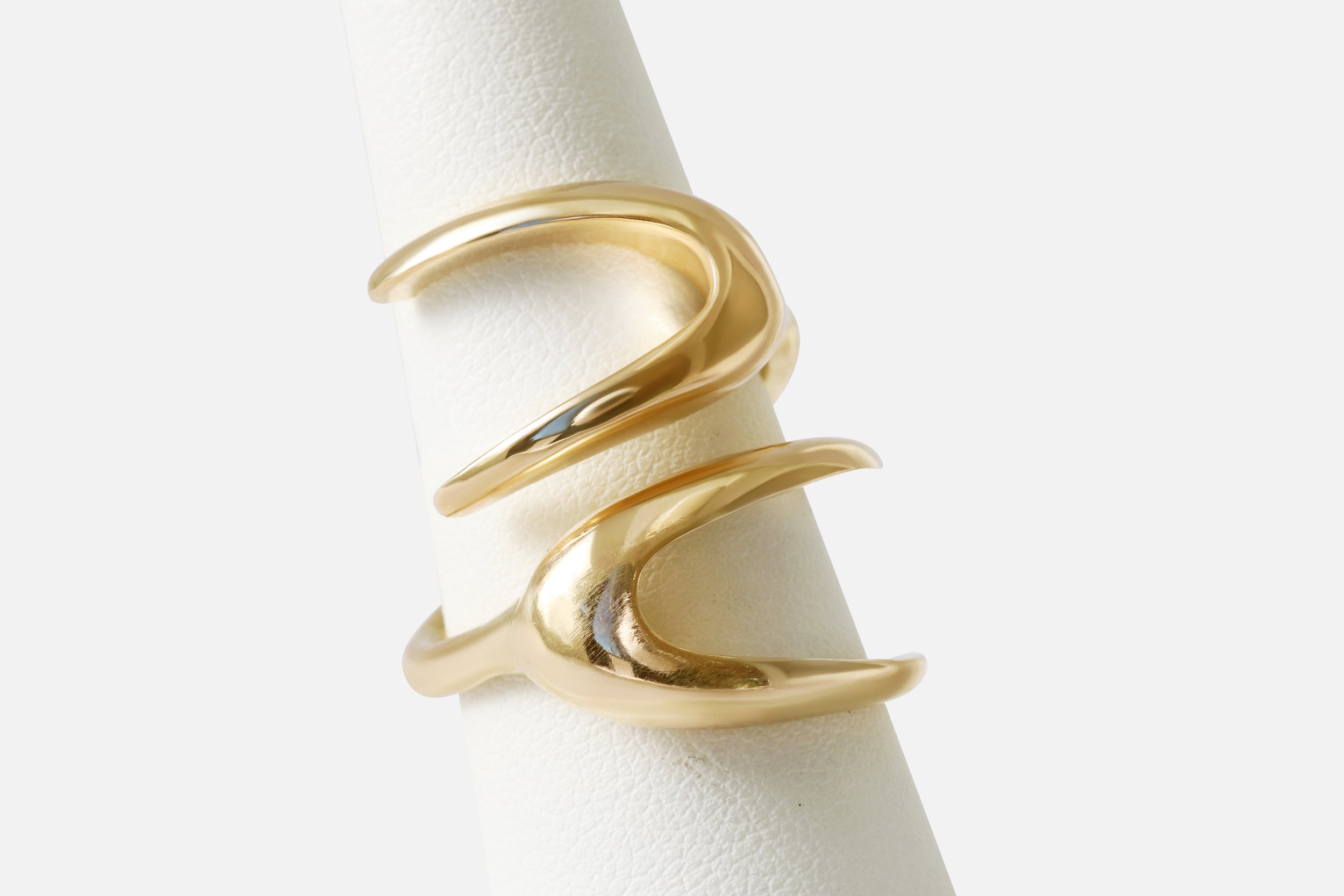 Angled view of X Ring By Lucia B Marti on stand