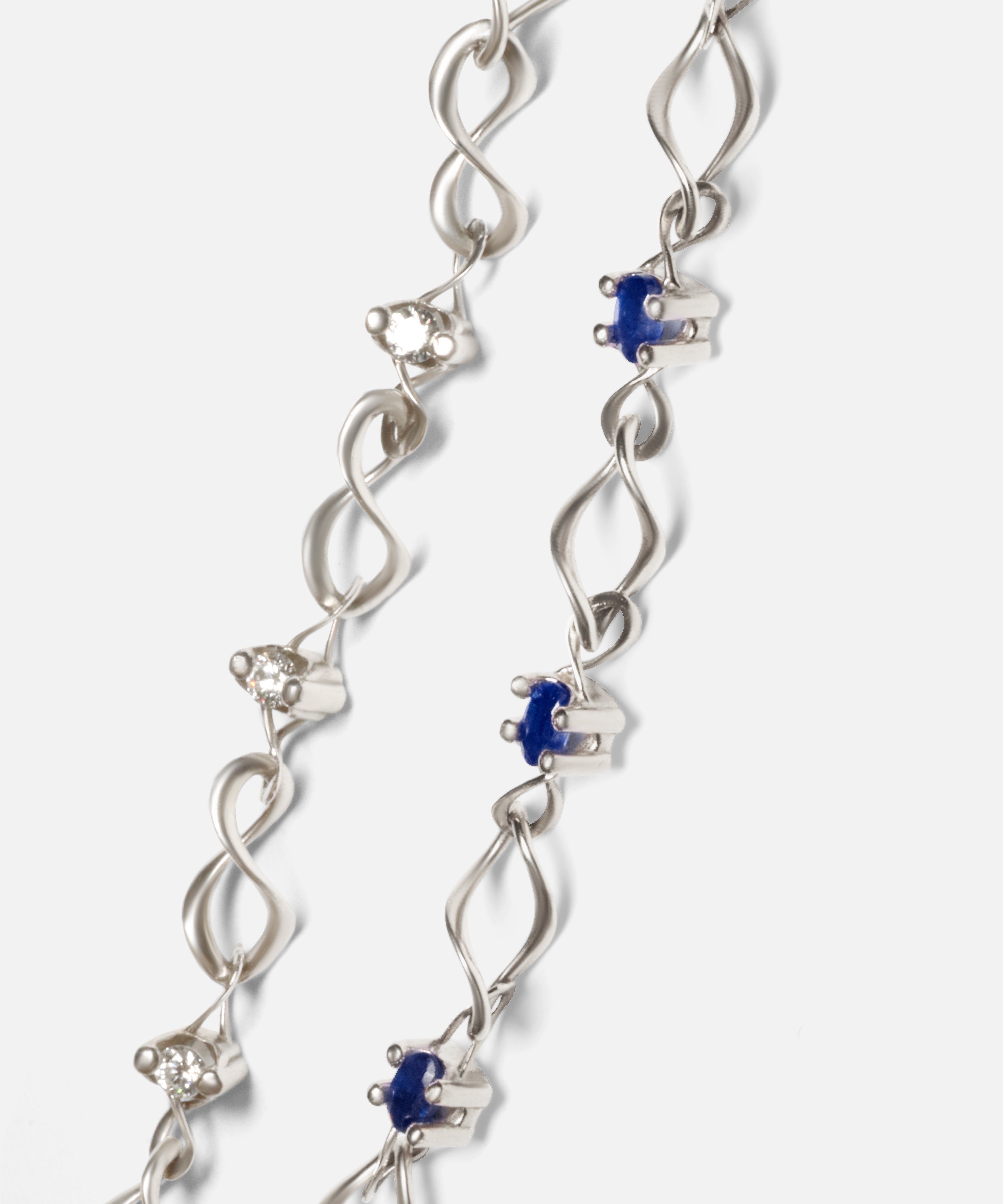 Close up group shot of Nucleus Intermittendi Bracelet / Sapphire in 14k white gold and Locus Intermittendi Bracelet	/ Diamonds by Lucia B Marti