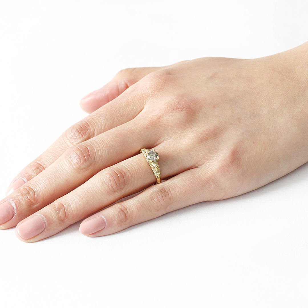 Model wears Skull and Flower Halo / Grey Diamond on ring finger