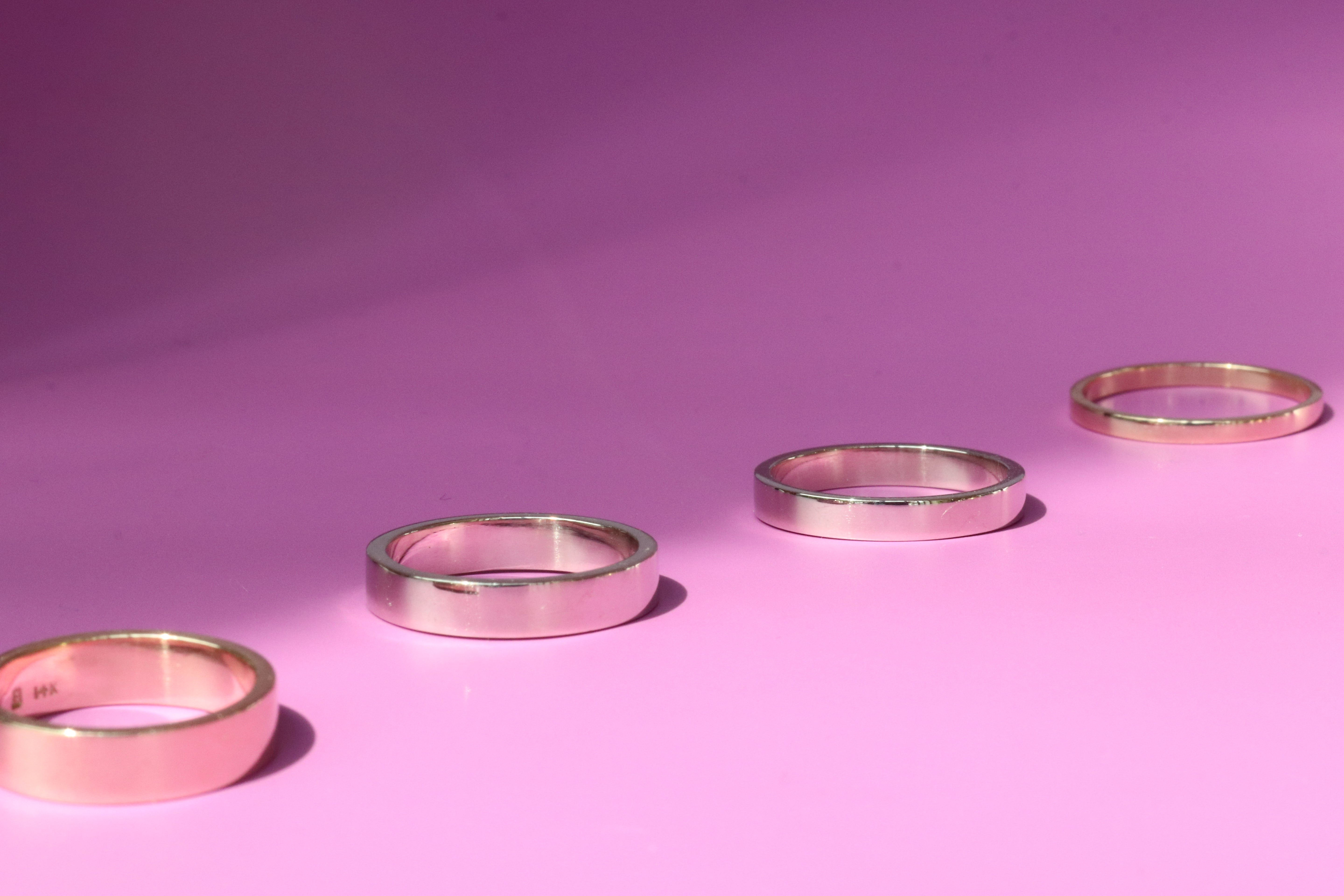 Group shot of all band width options featuring Flat Band / 5.5mm Customizable, Flat Band / 4.5mm Customizable, Flat Band / 3.5mm Customizable,  and Flat Band / 2mm Customizable