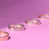 Group shot of all band width options featuring Flat Band / 5.5mm Customizable, Flat Band / 4.5mm Customizable, Flat Band / 3.5mm Customizable,  and Flat Band / 2mm Customizable