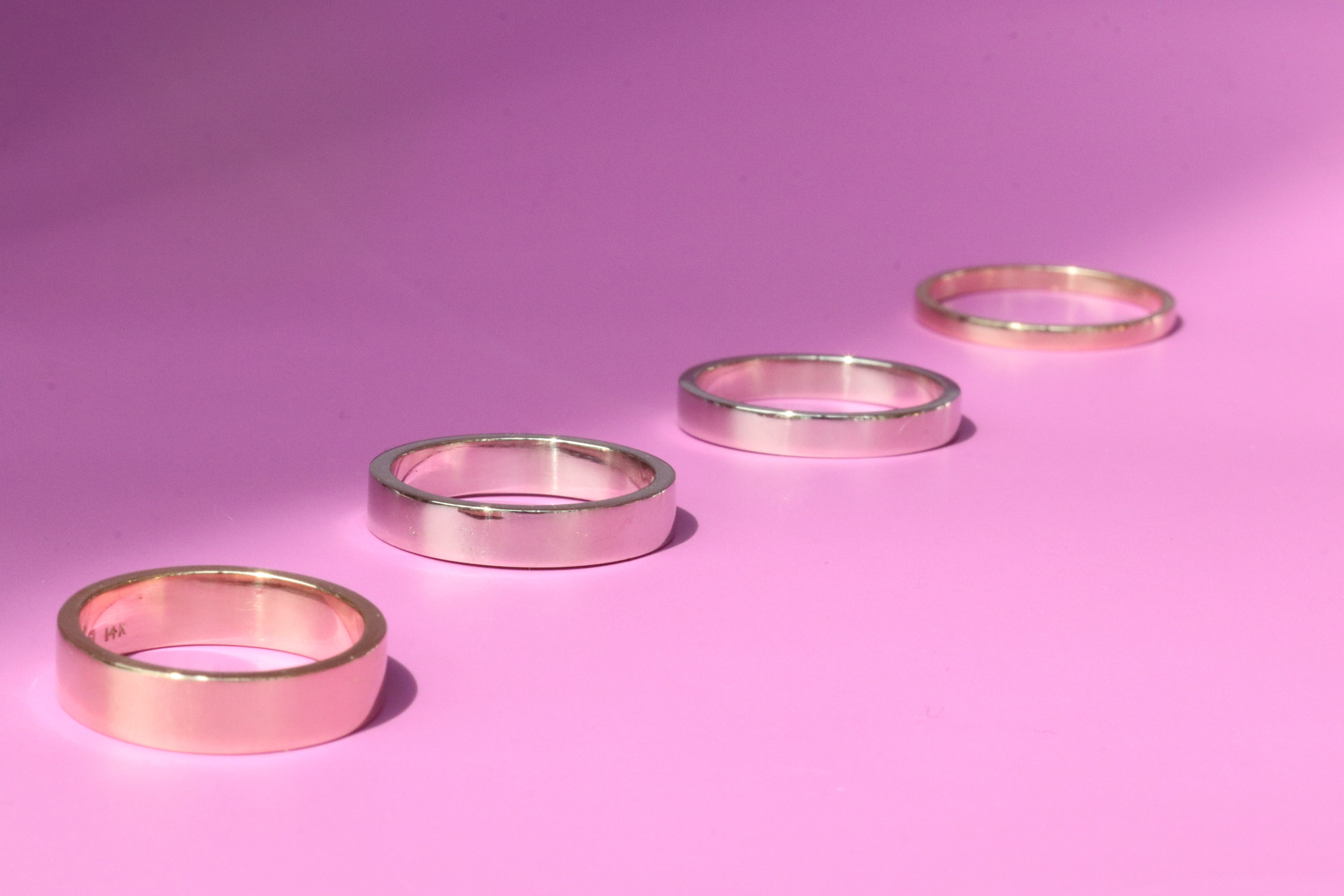 Group shot of all band width options featuring Flat Band / 5.5mm Customizable, Flat Band / 4.5mm Customizable, Flat Band / 3.5mm Customizable,  and Flat Band / 2mm Customizable