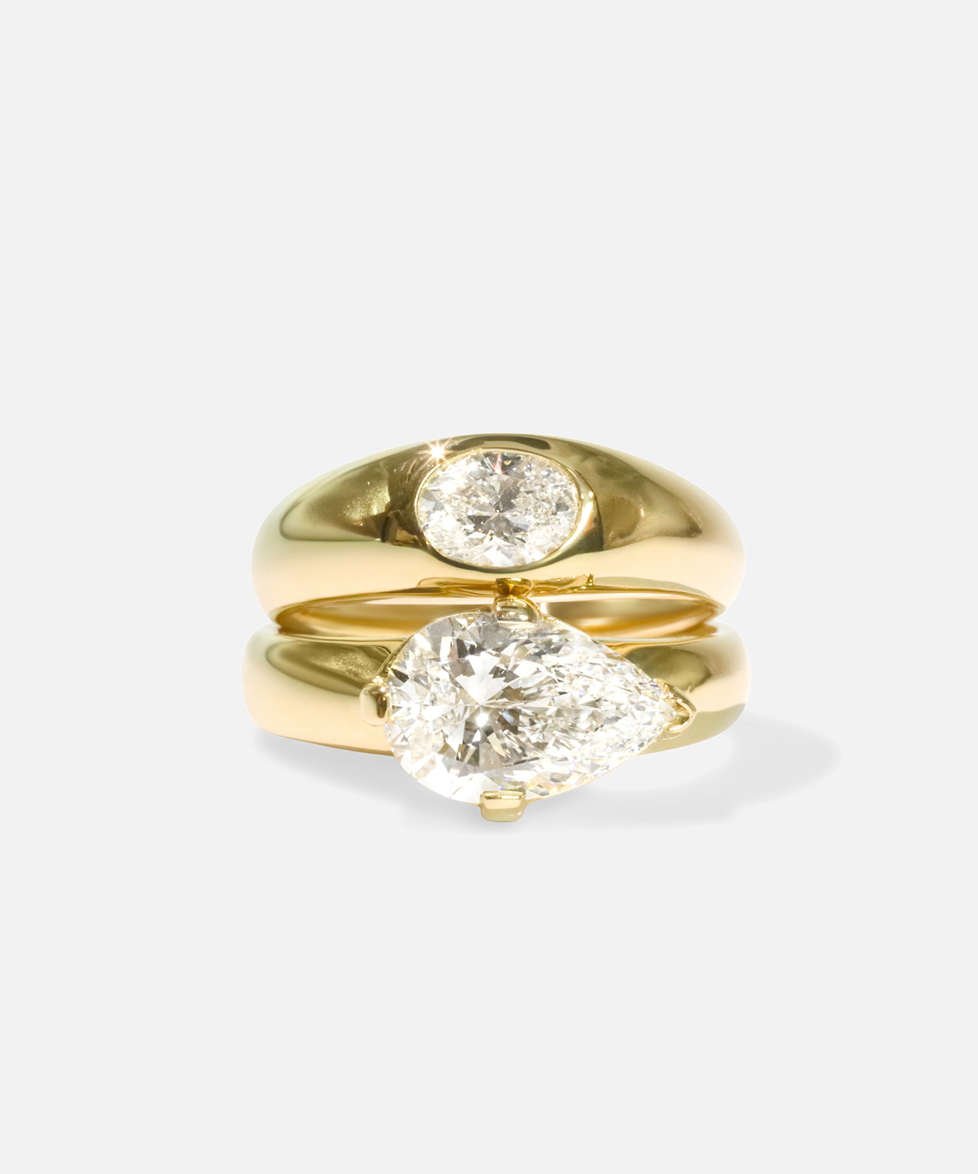 Group fully stacked view of Optic Oval Signet Ring / Diamond in 14k yellow gold and Comet Ring / Lab Pear Diamond in 14k yellow gold by Joko