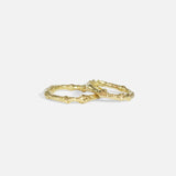 Stacked group shot of Bone Tree Band / Small and Bone Tree Band / Large in 14k yellow gold by Ides
