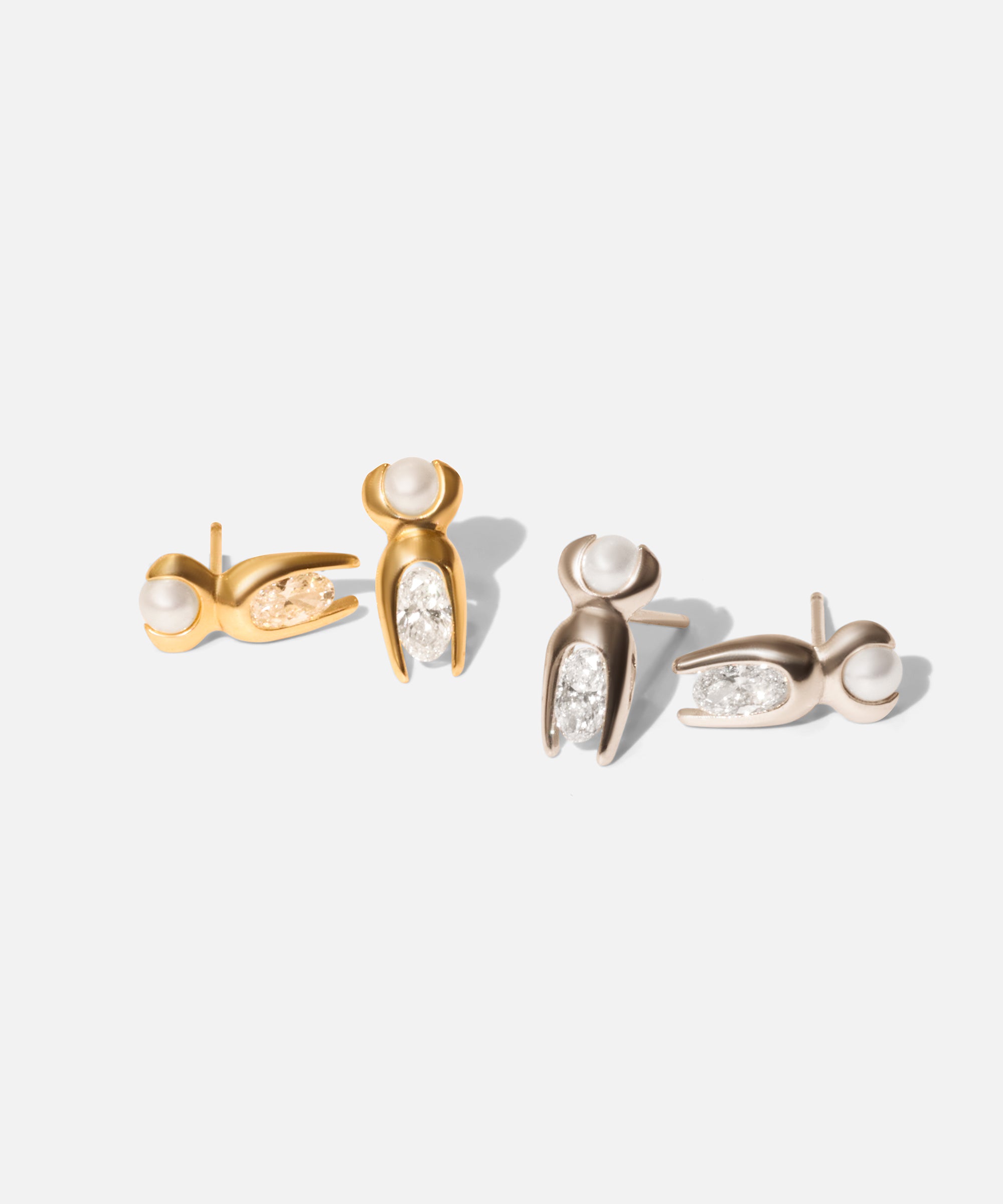 Group shot of Mutation Earrings / Pearl & Diamond in 14k yellow gold and 14k white gold by Lucia B Marti
