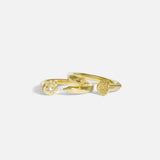 Group stacked shot of Twisted Nail Ring in 14k yellow gold and Diamond Twisted Nail Ring in 14k yellow gold by Ides