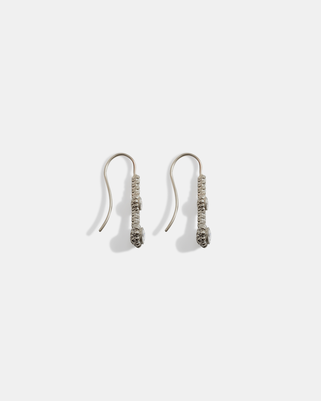 Side view of Skull Double Drop	Earrings in 18k white gold