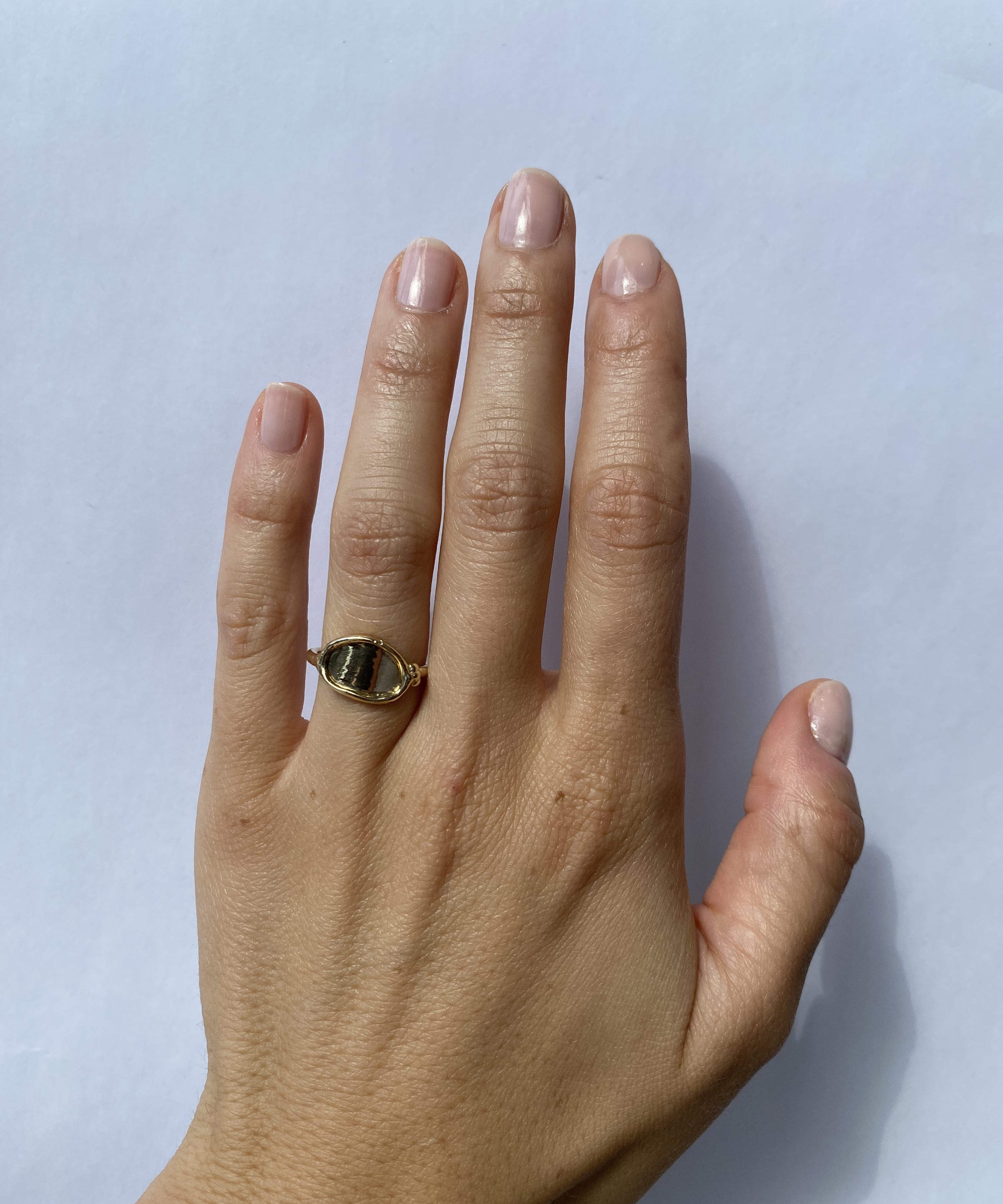 Model wears Reflection Ring III on ring finger