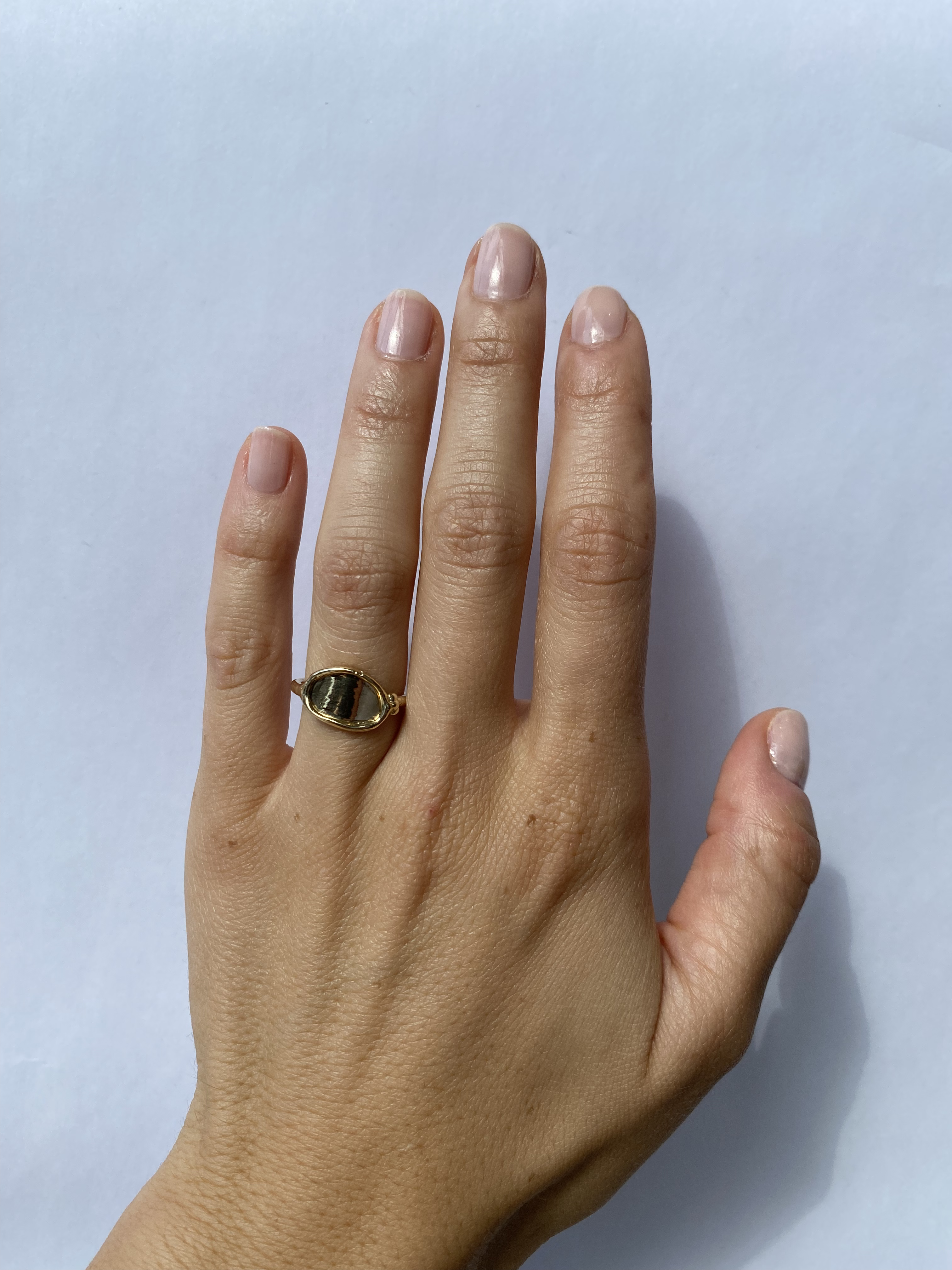 Model wears Reflection Ring III on ring finger