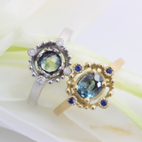 Lifestyle shot of a pair of Melee Halo / E11 Bi-Color Sapphire rings in platinum and 14k yellow gold by Hiroyo