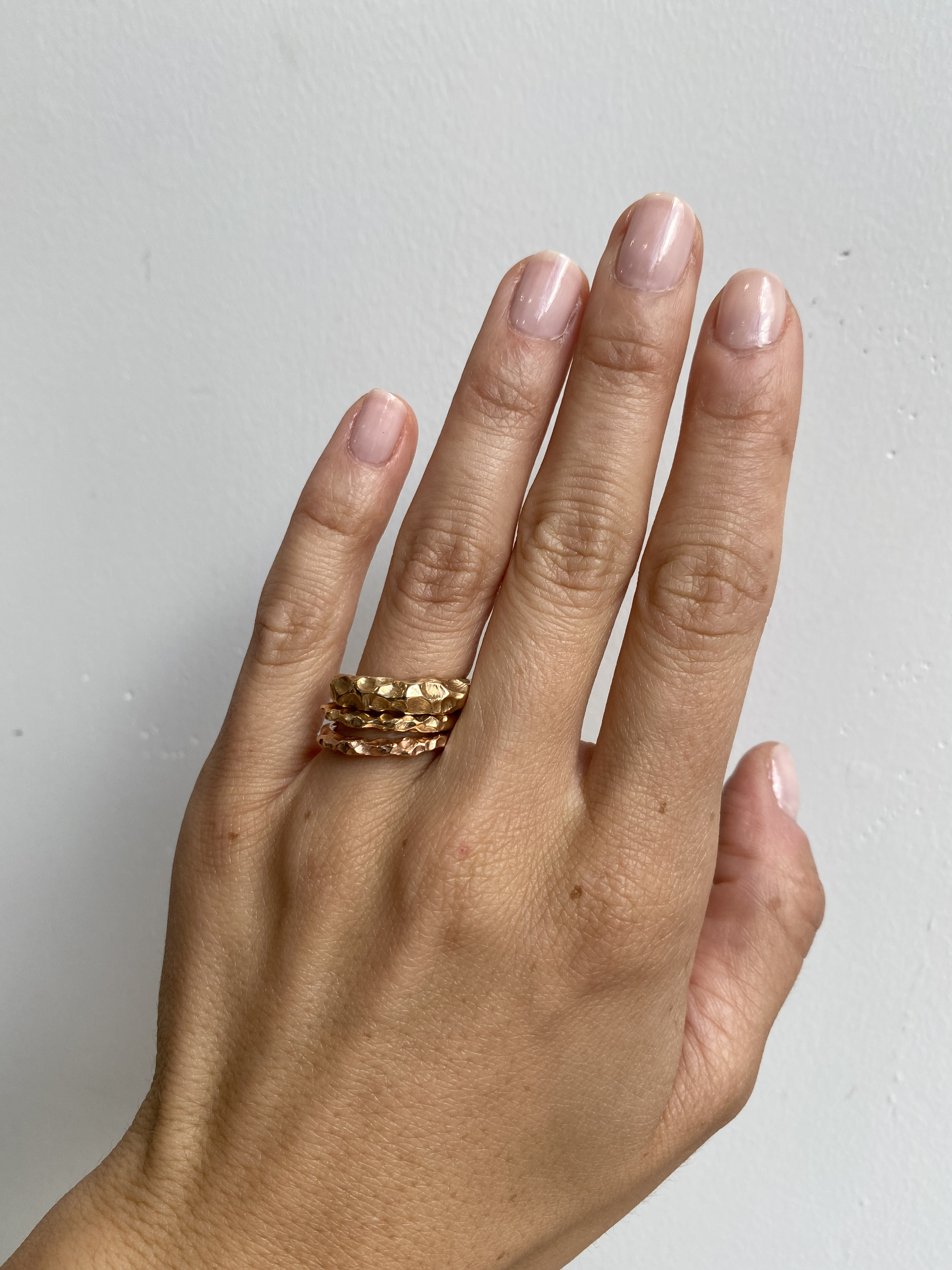 Model wears Rough Water Band in various widths on ring finger By O