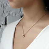 Model wears Skull Drop Down Pendant in 18k Red Gold