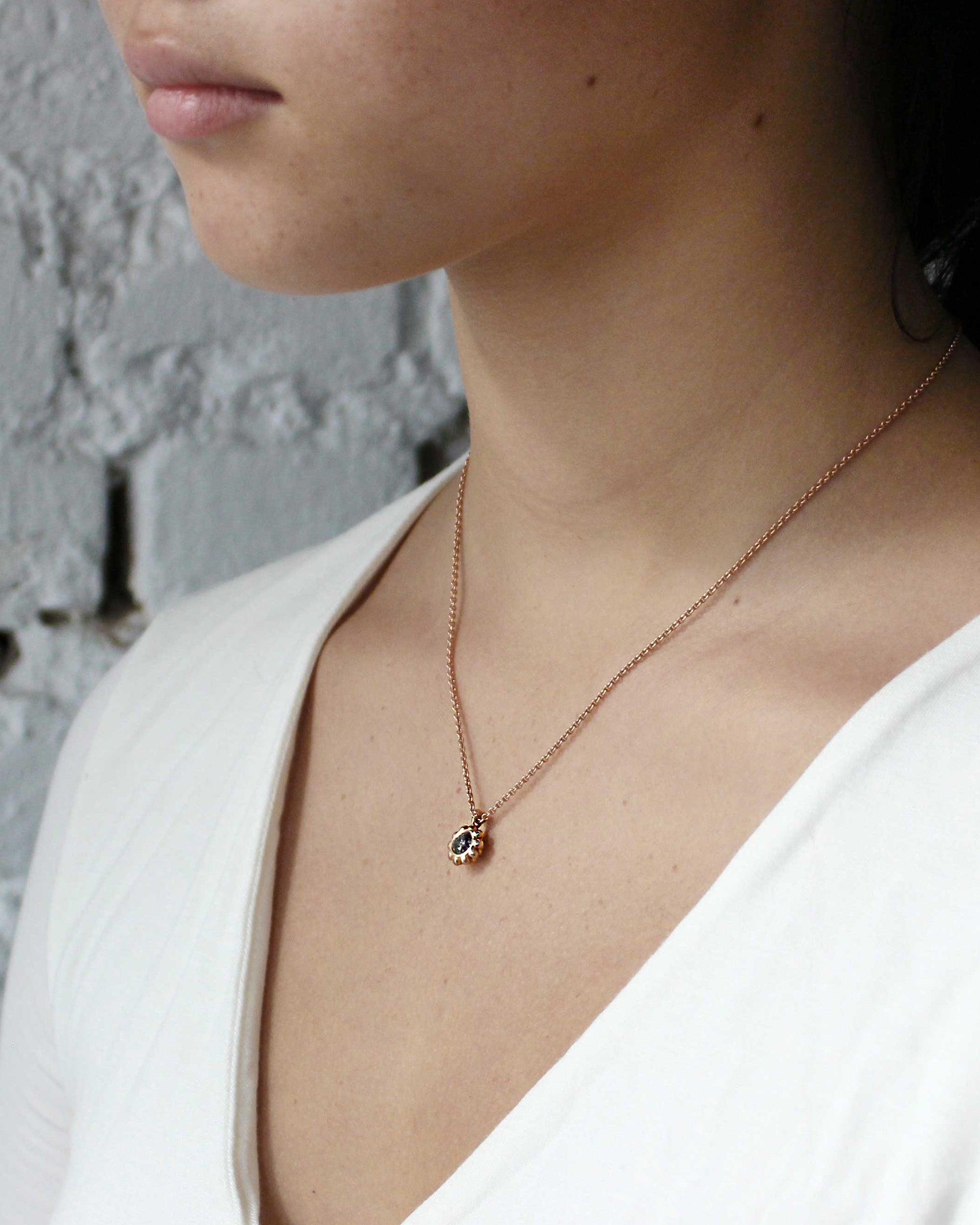 Model wears Skull Drop Down Pendant in 18k Red Gold
