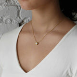 Model wears Skull Pass Thru Pendant in 18k yellow gold
