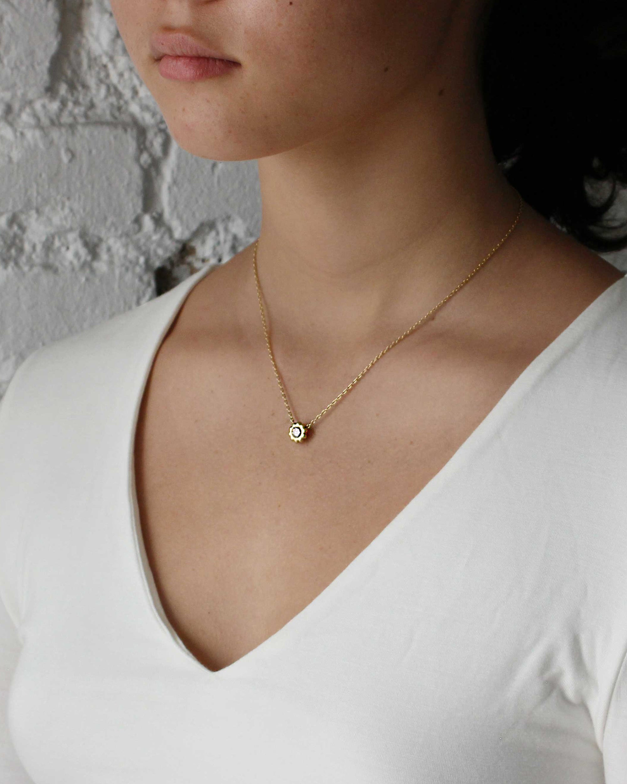 Model wears Skull Pass Thru Pendant in 18k yellow gold