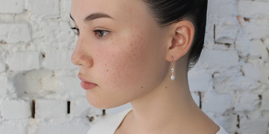 Model wears Skull Double Drop	Earrings in 18k white gold