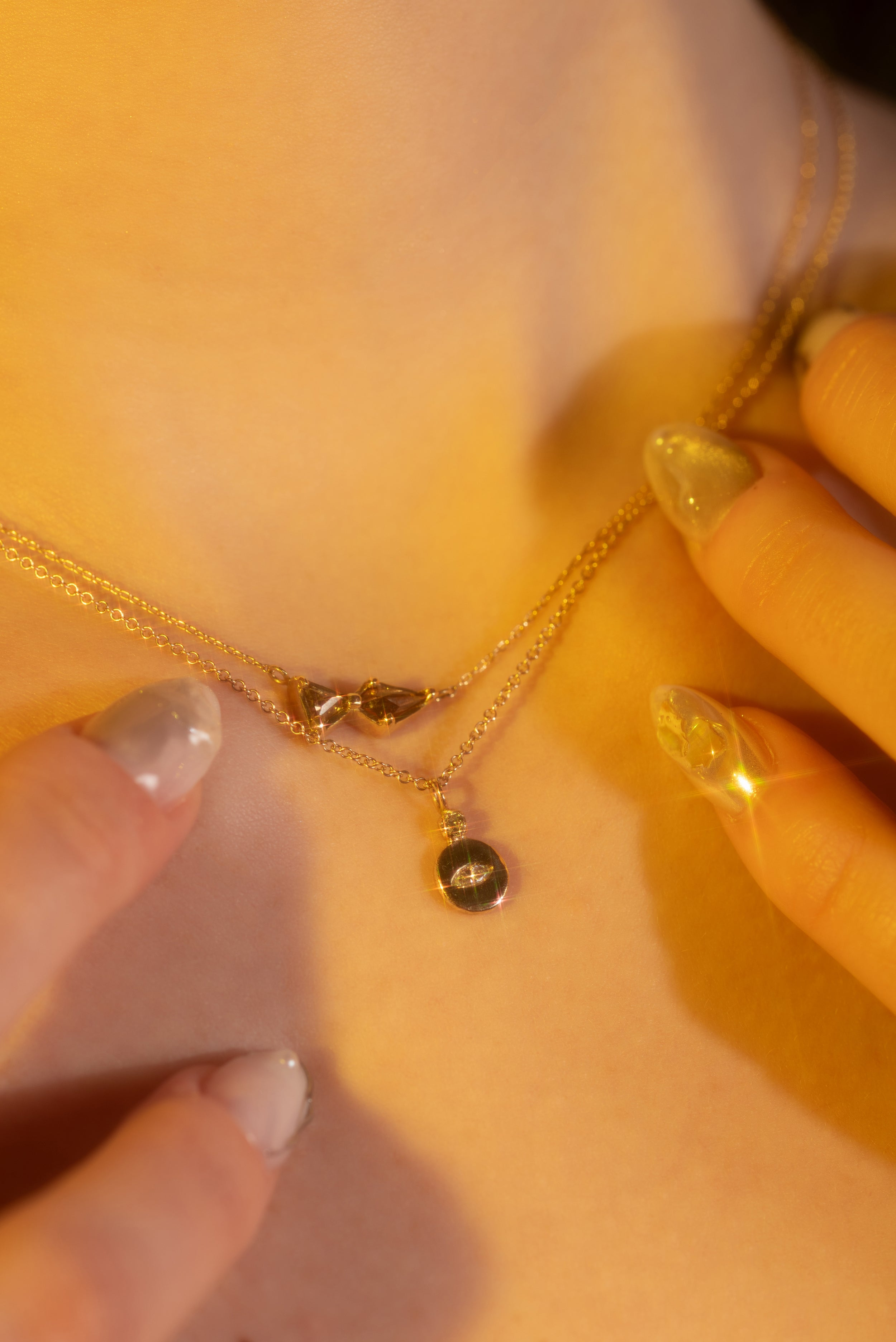 Model wears Evil Eye Diamond Necklace by Alfonzo and Dew 25 / Cognac + Brown Sugar Diamond Pendant by Hiroyo