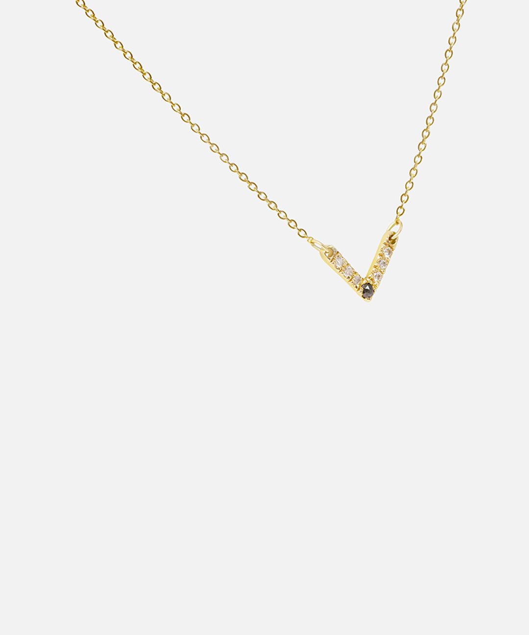 Side view of White and Black Diamond Pendant in 14k yellow gold