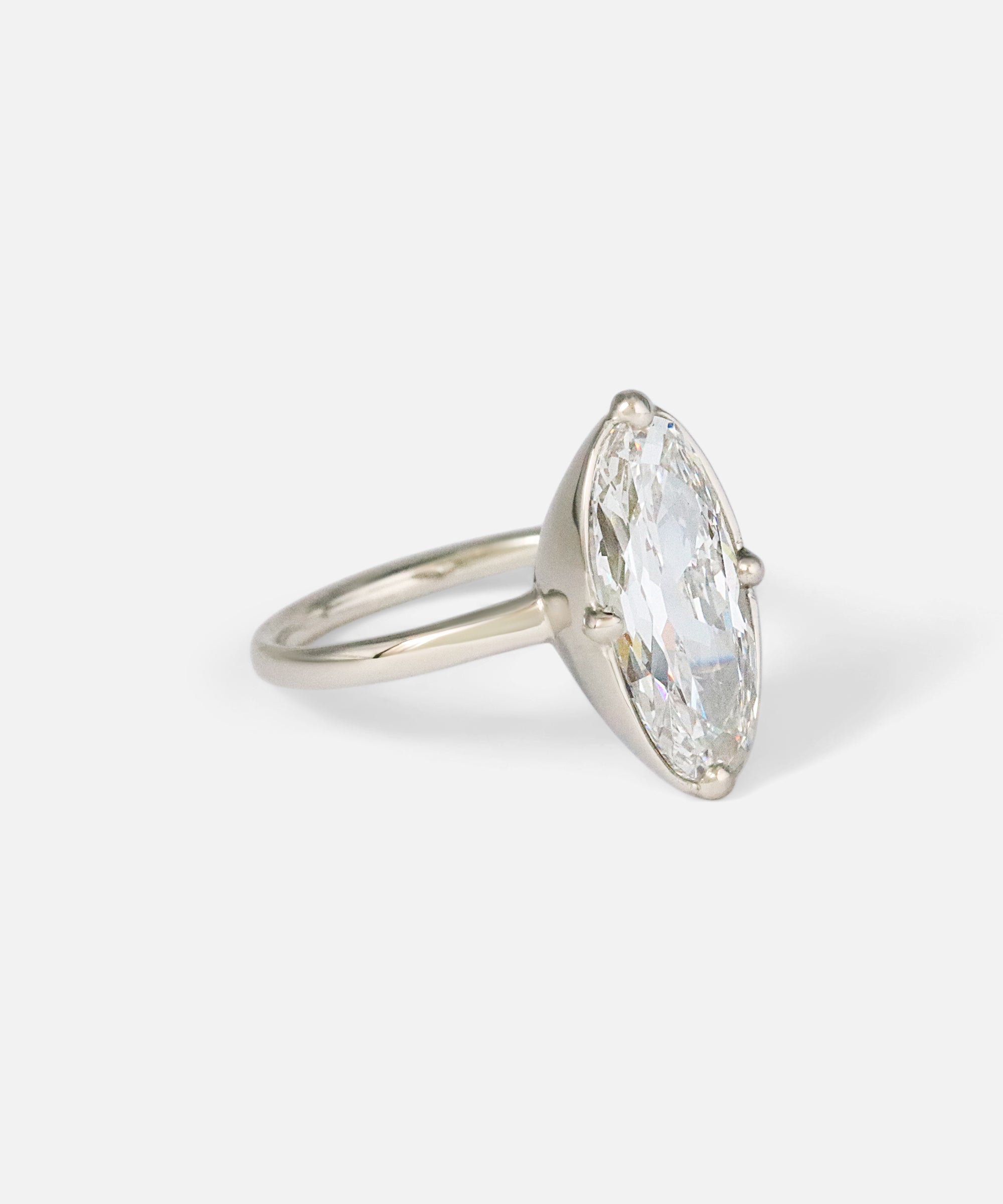 Angled side view of Dew 55 / Modified Oval Cut Diamond Ring by Hiroyo