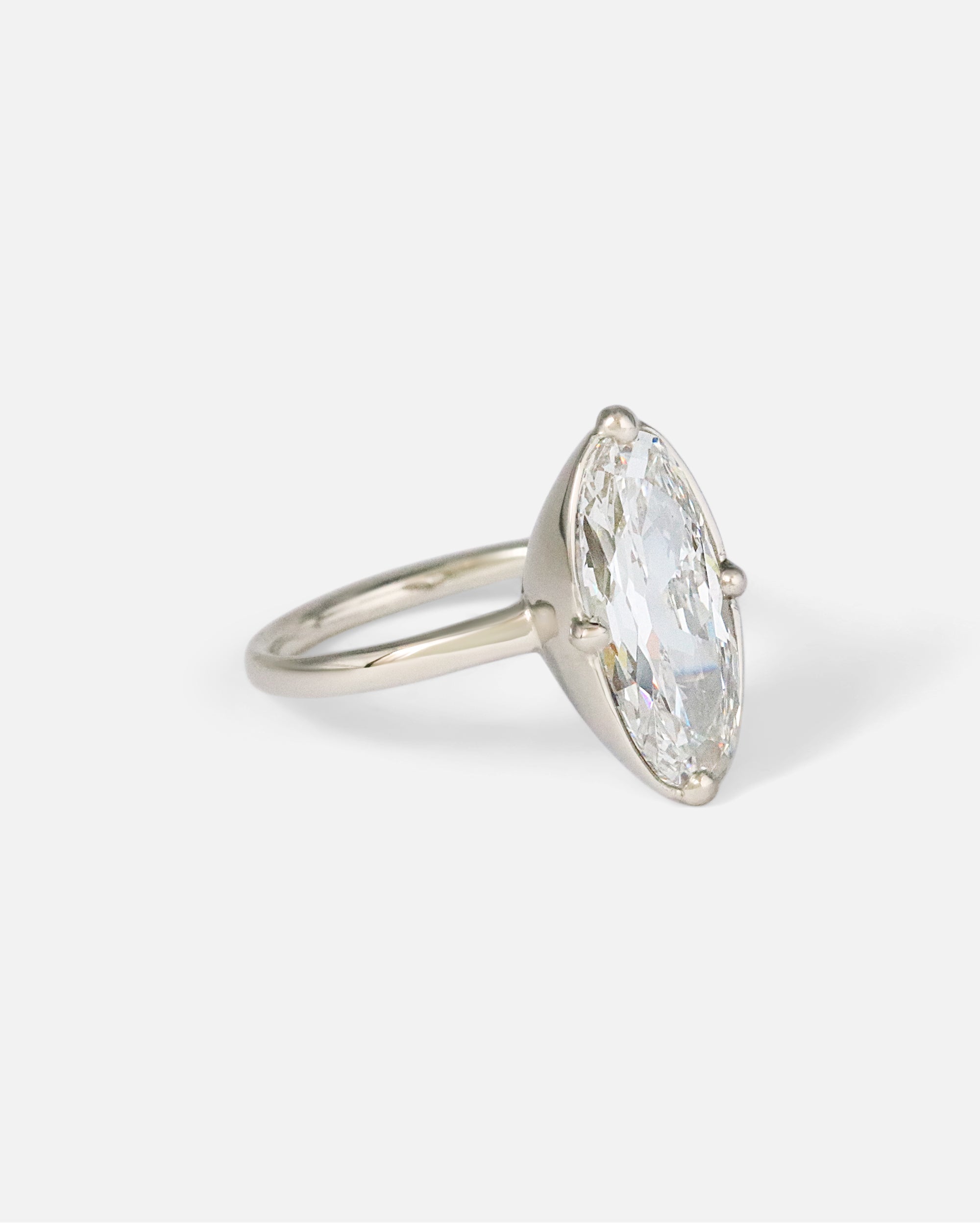 Angled side view of Dew 55 / Modified Oval Cut Diamond Ring by Hiroyo