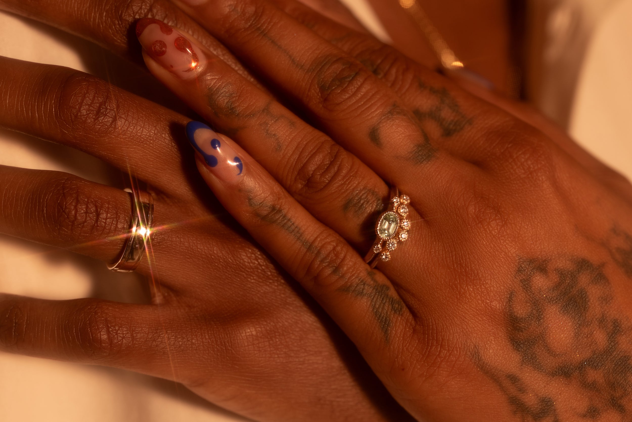 Models embracing hands showing rings from our matrimony collection