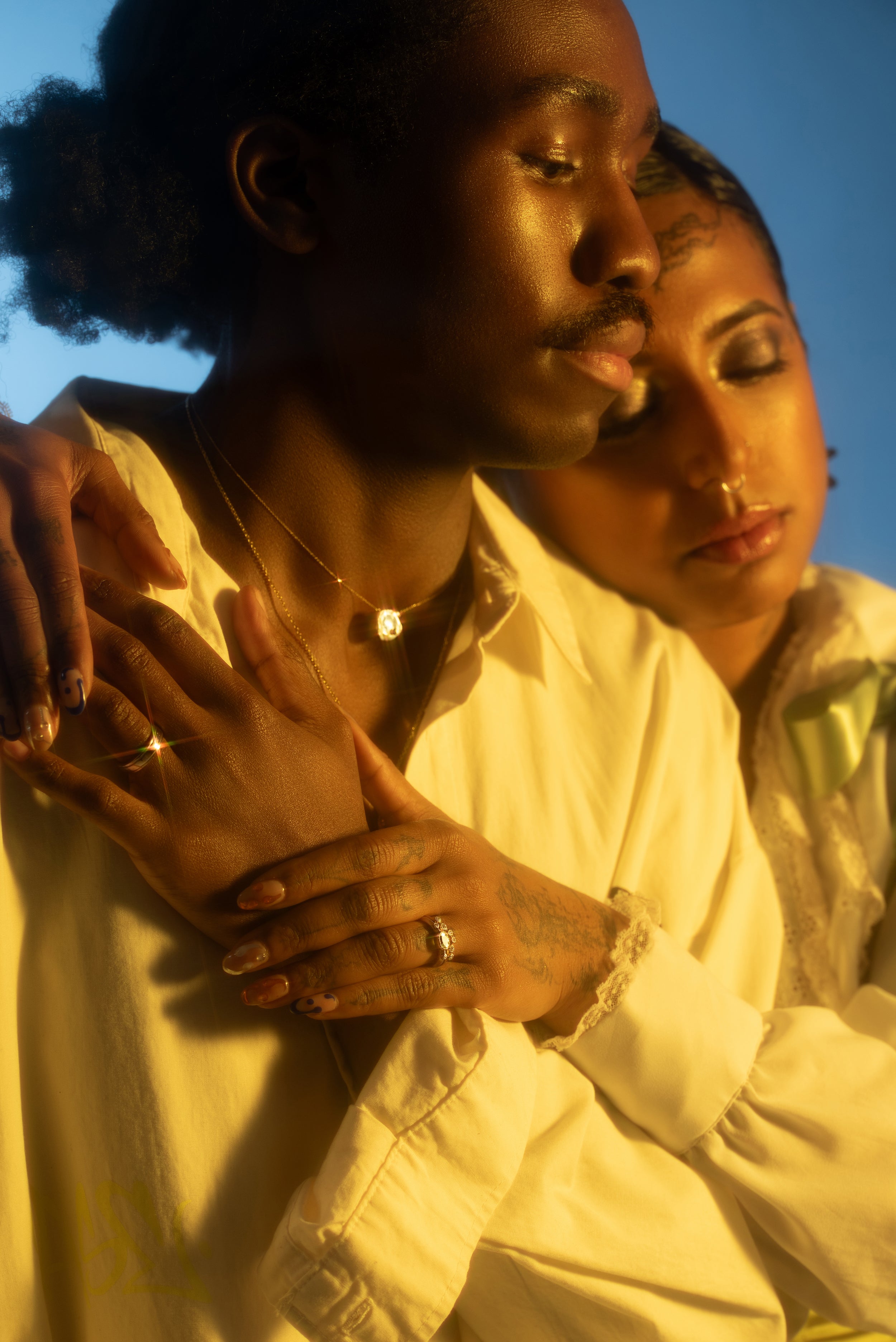 Models embrace hands while showing new fine jewelry featured in our in This Moment lookbook