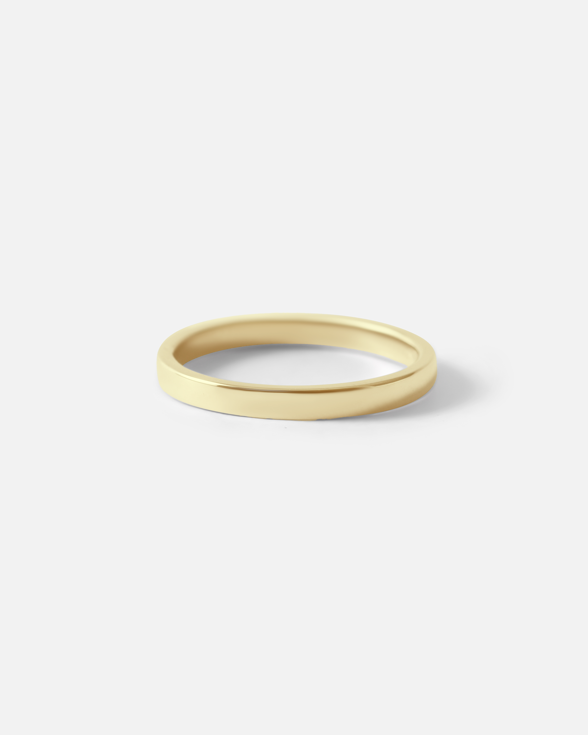 Angled view of Flat Band / 2mm Customizable By Hiroyo in 14k yellow gold