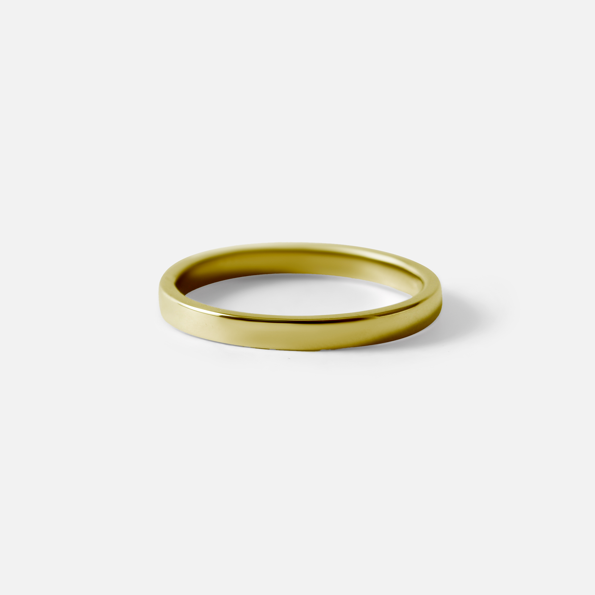 Angled view of Flat Band / 2mm Customizable By Hiroyo in 18k yellow gold