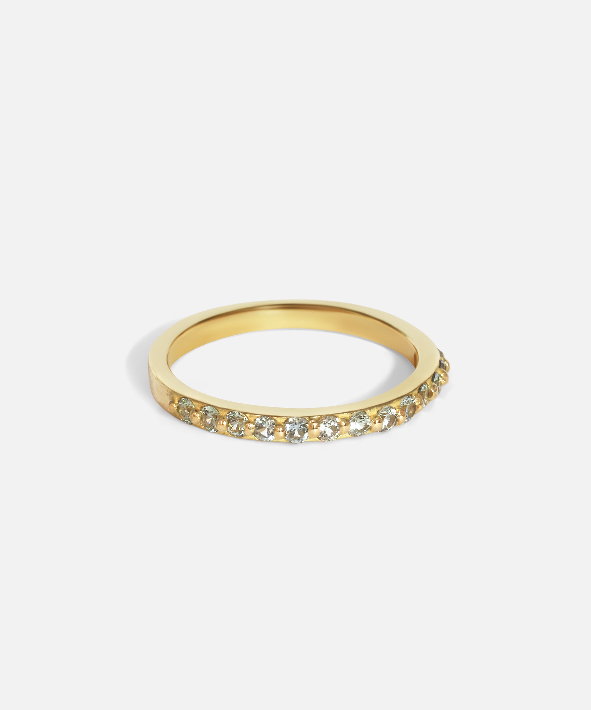 Side view of Dew 3mm / Blue Green Sapphire in 18k yellow gold by Hiroyo