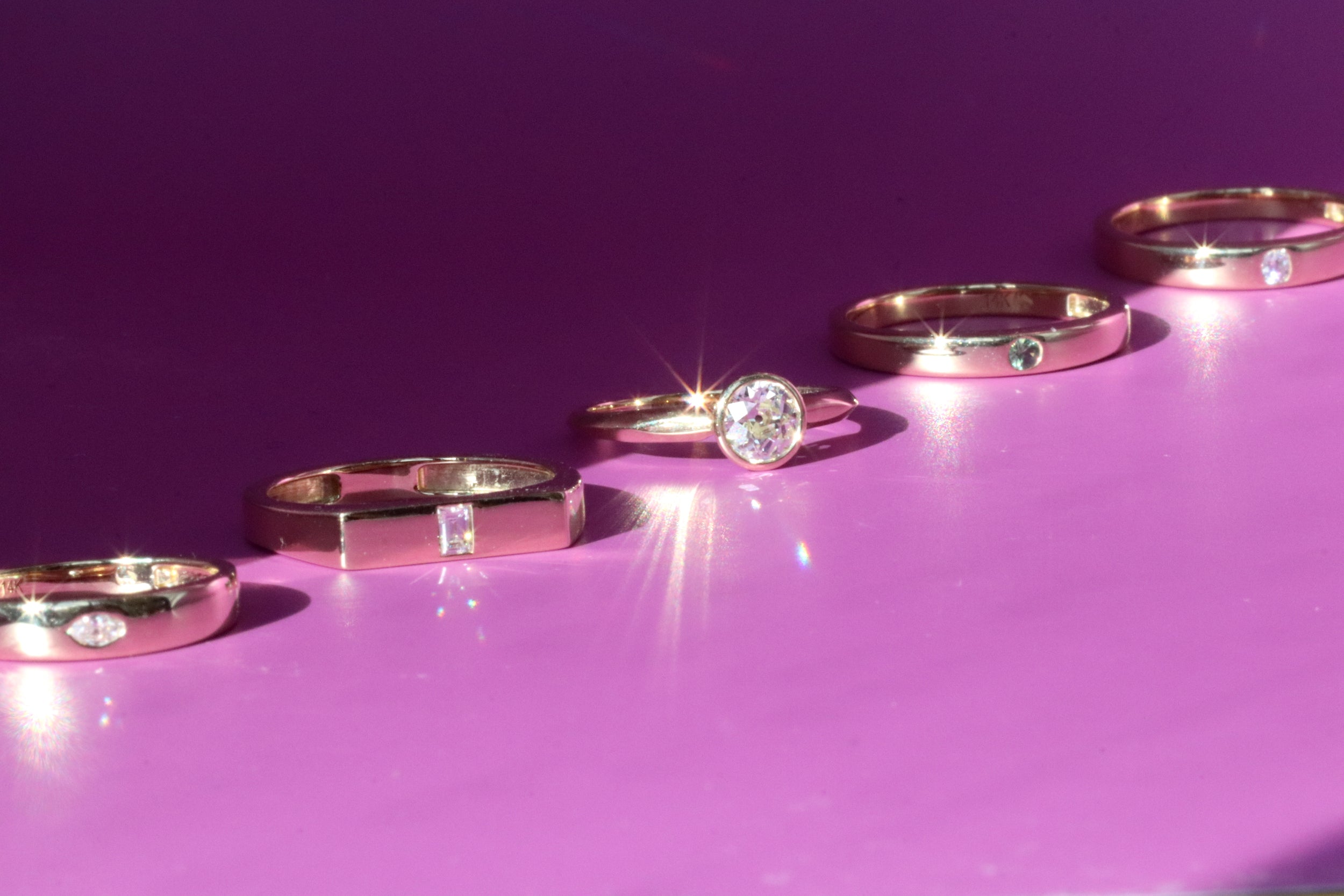 Diagonal group of wedding bands and engagement rings from Casual Seance.