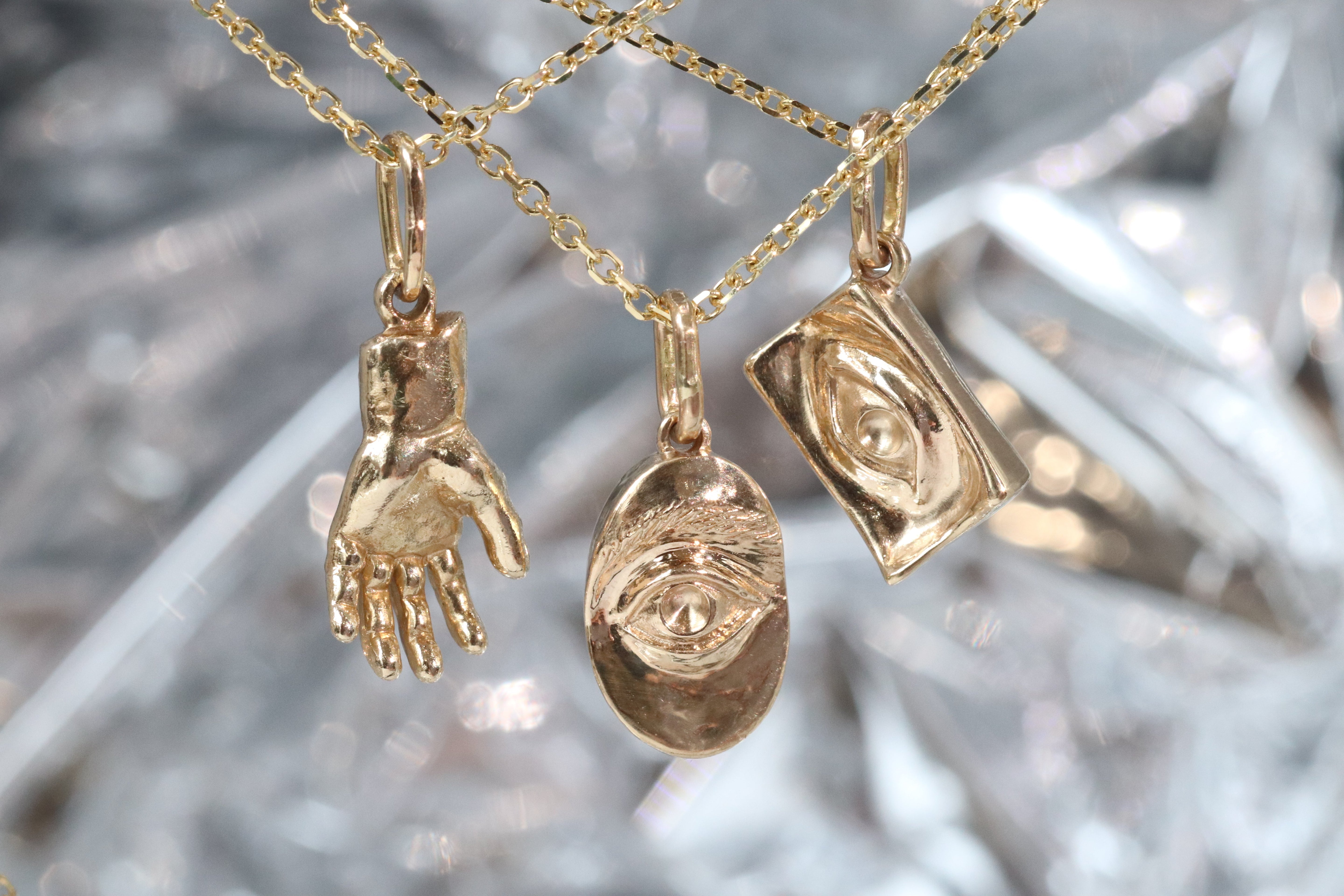Group shout of Theia Pendant, Intagliuax Oval Pendant, and Intagliuax Pendant