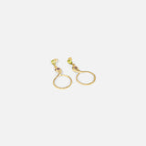 Angled flat lay view of Ophidia Drop Circuli Earrings by Ides
