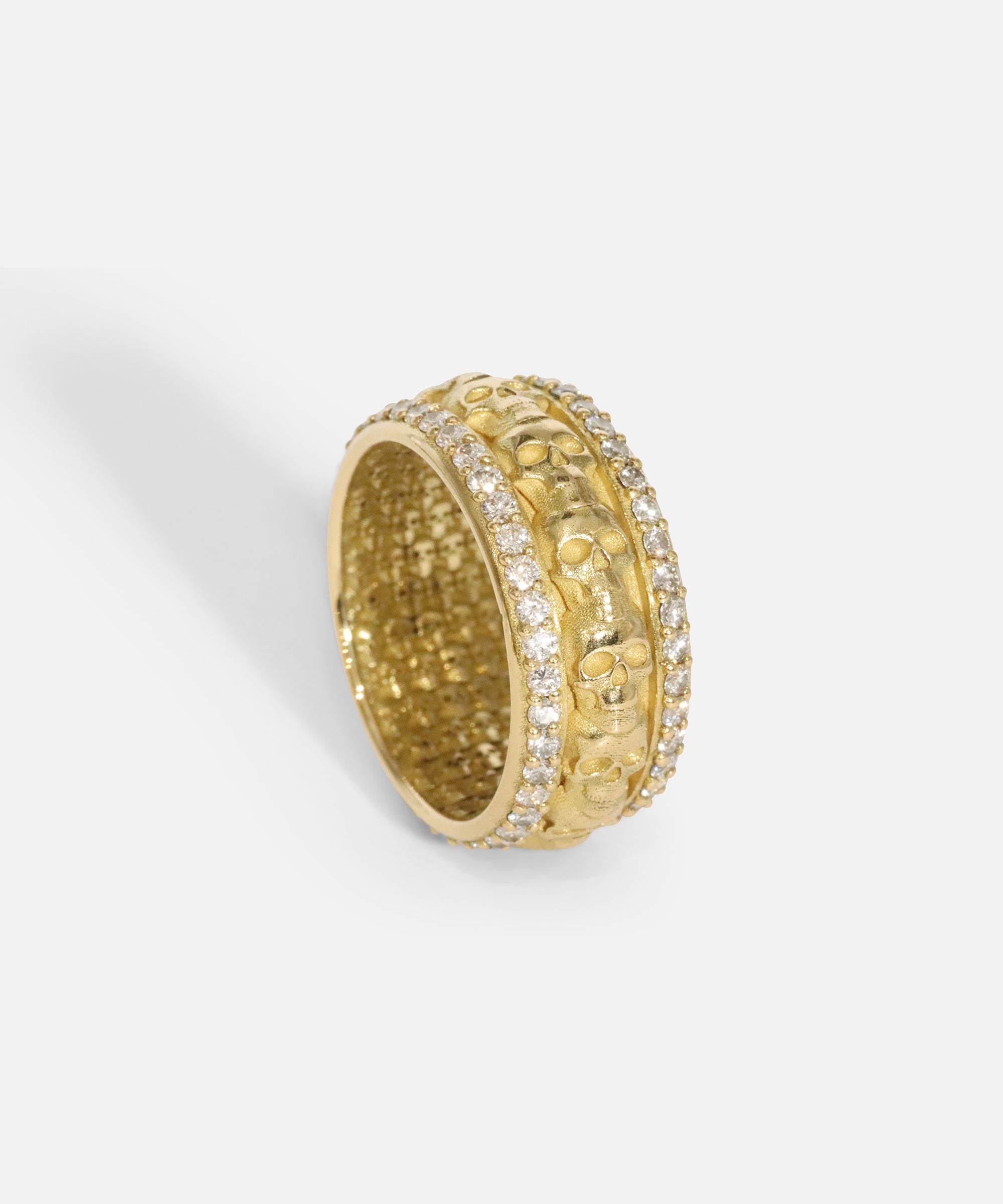 Angled ertical view of Skulls In A Line Band / Pave White Diamonds showcasing out details by Fitzgerald Jewelry