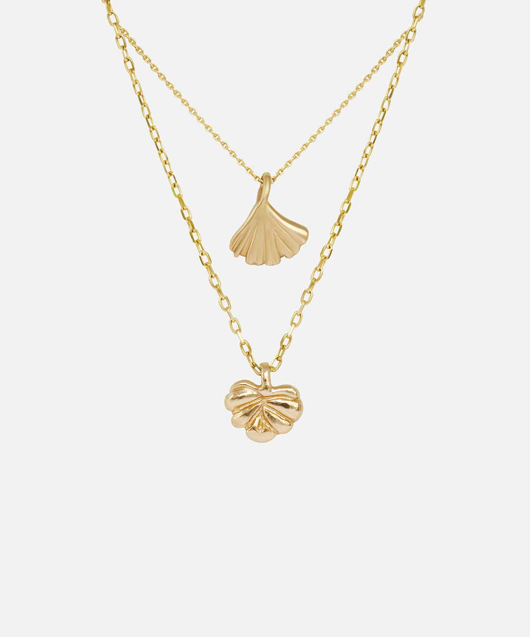 Front view of Ginkgo Necklace in 14k yellow gold and Lotus Necklace in 14k yellow gold hanging together