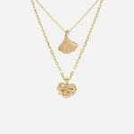Front view of Ginkgo Necklace in 14k yellow gold and Lotus Necklace in 14k yellow gold hanging together