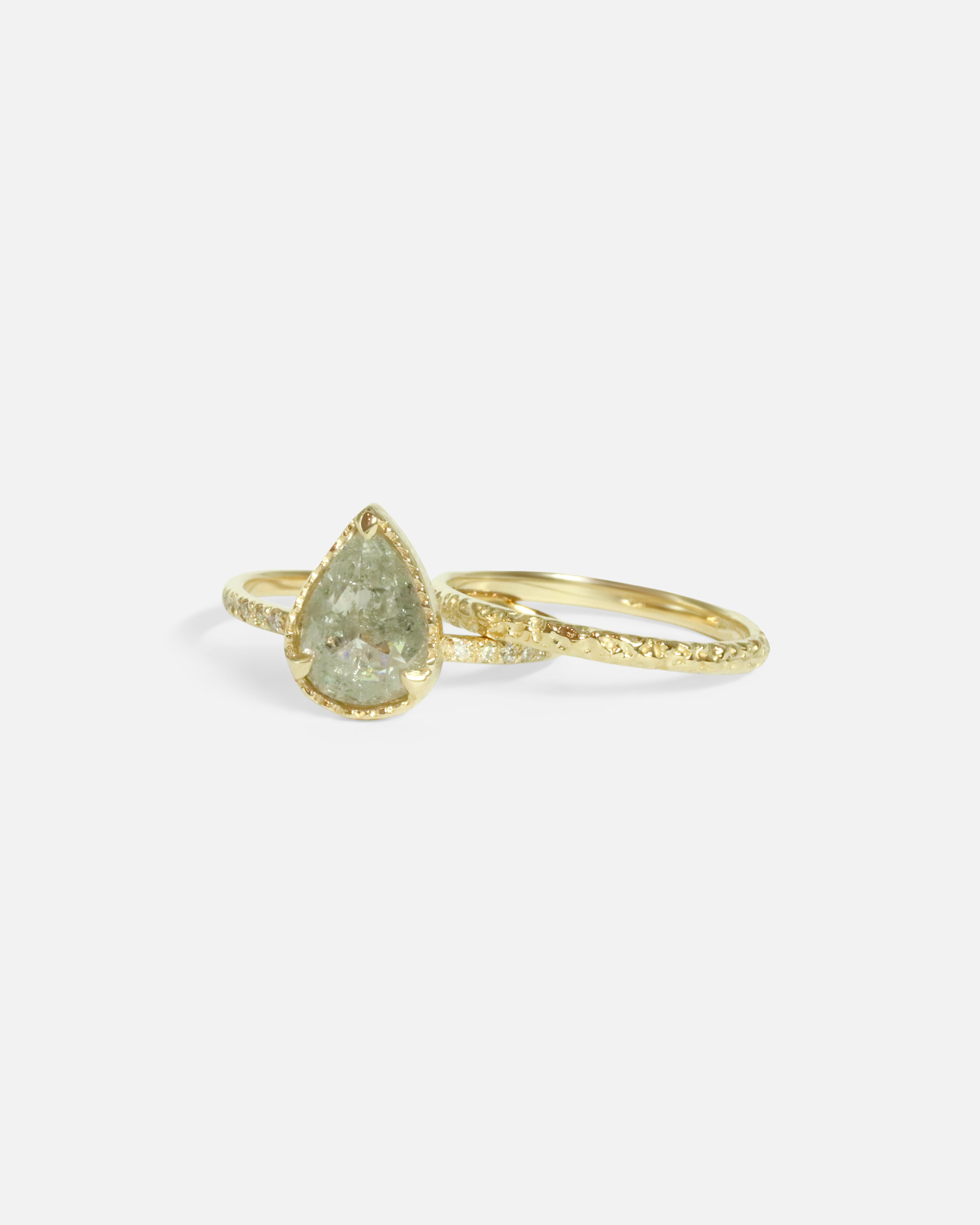 Stacked front view of Lava Textured Band and Pear Shaped Grey Diamond Ring by Ariko
