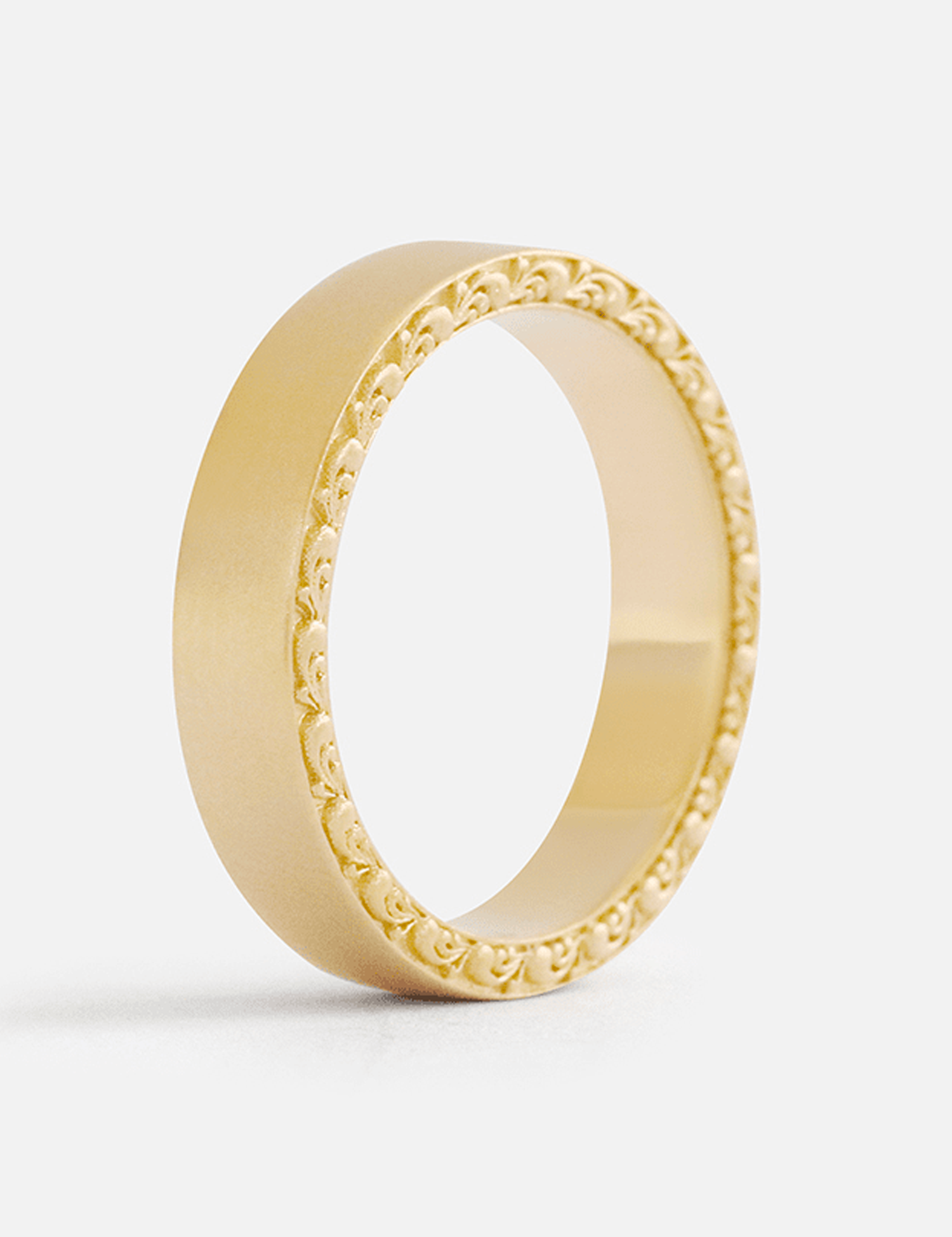 Angled view of a custom enrgraved wedding band created by Fitzgerald Jewelry