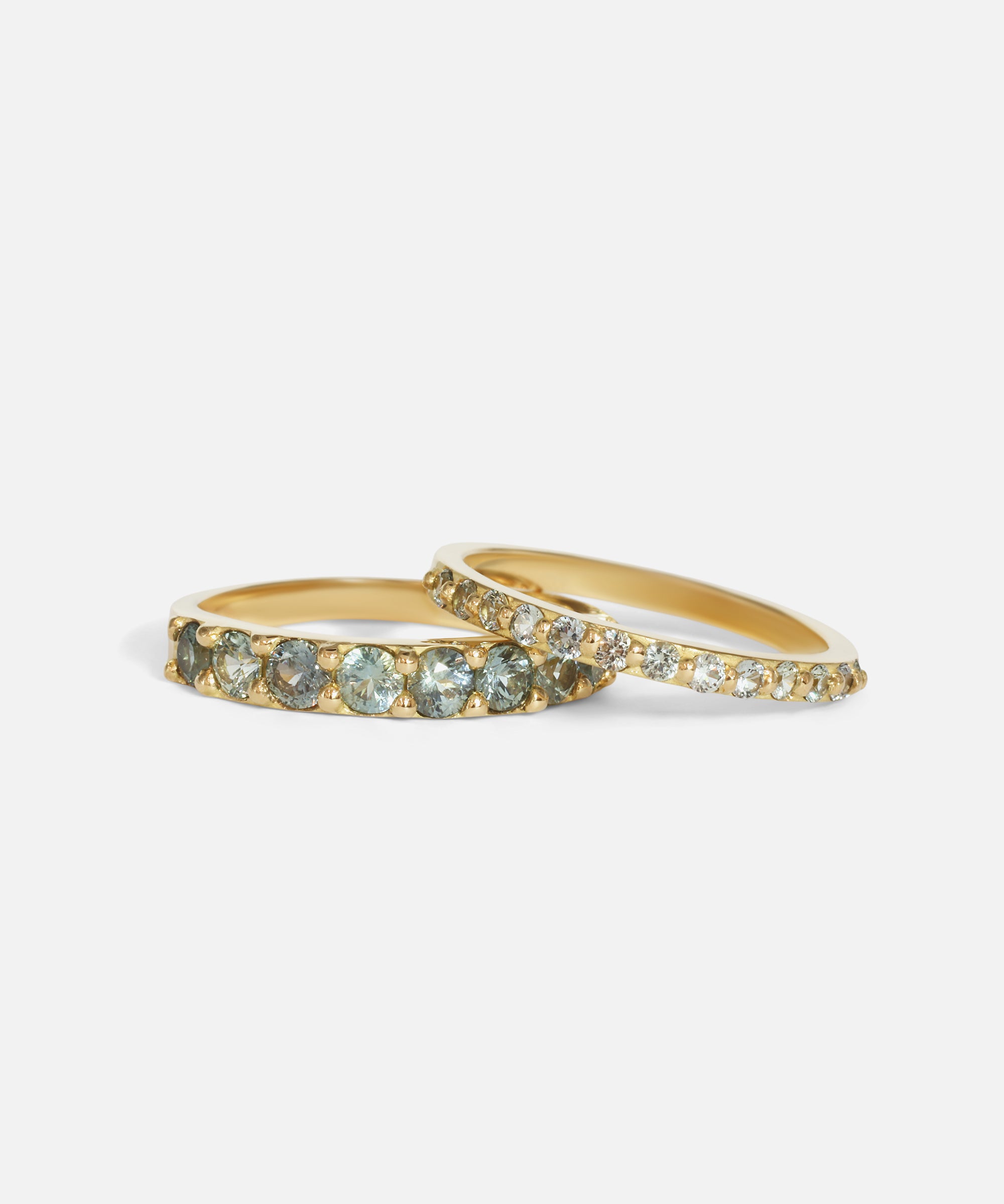 Group stacked view of Dew 3mm / Blue Green Sapphire in 18k yellow gold and Dew 1.75mm / Blue Green Sapphire in 18k yellow gold by Hiroyo