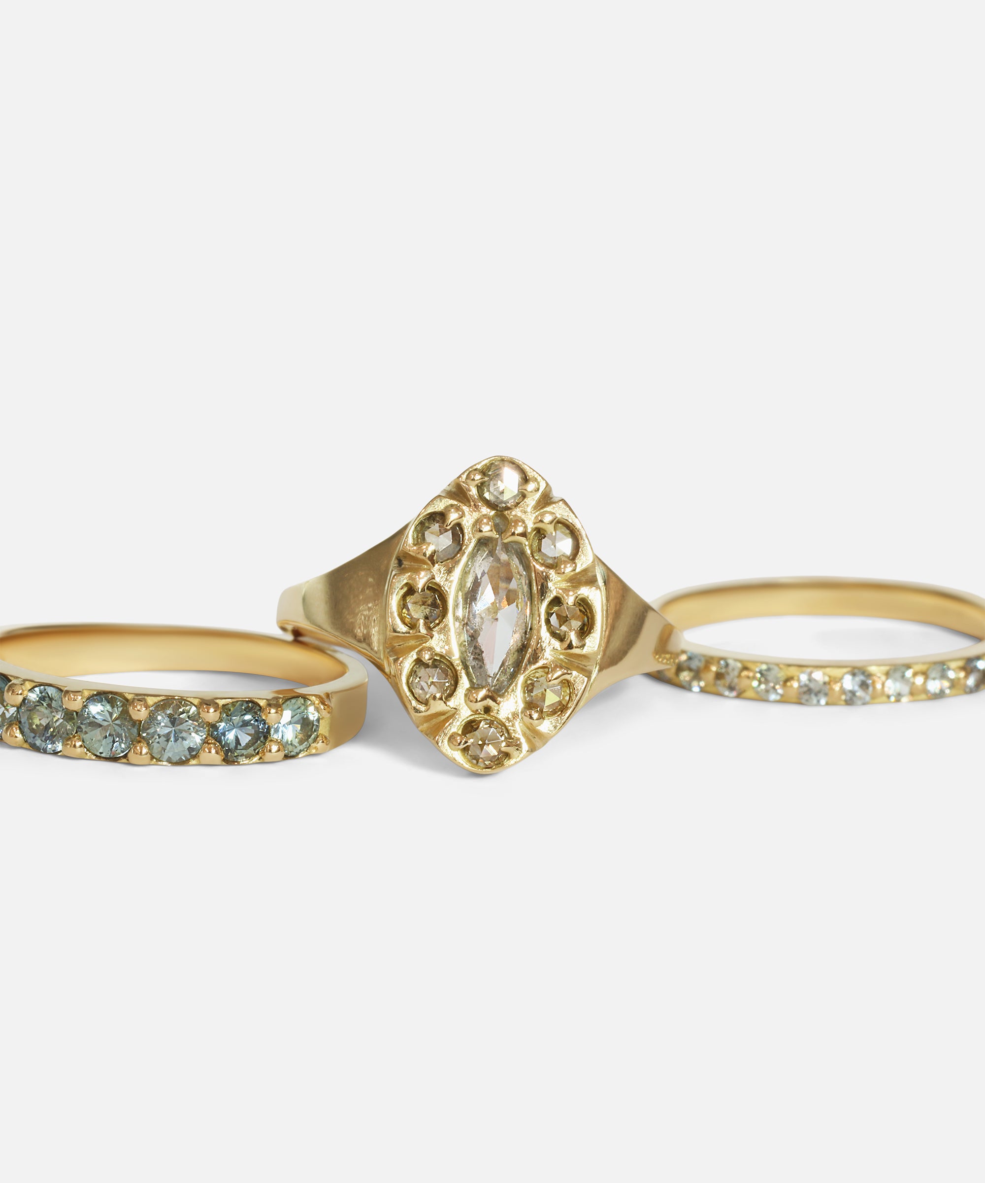 Group stacked view of Dew 3mm / Blue Green Sapphire in 18k yellow gold, Dew 41 / Colored Diamonds in 18k yellow gold, and Dew 1.75mm / Blue Green Sapphire in 18k yellow gold by Hiroyo