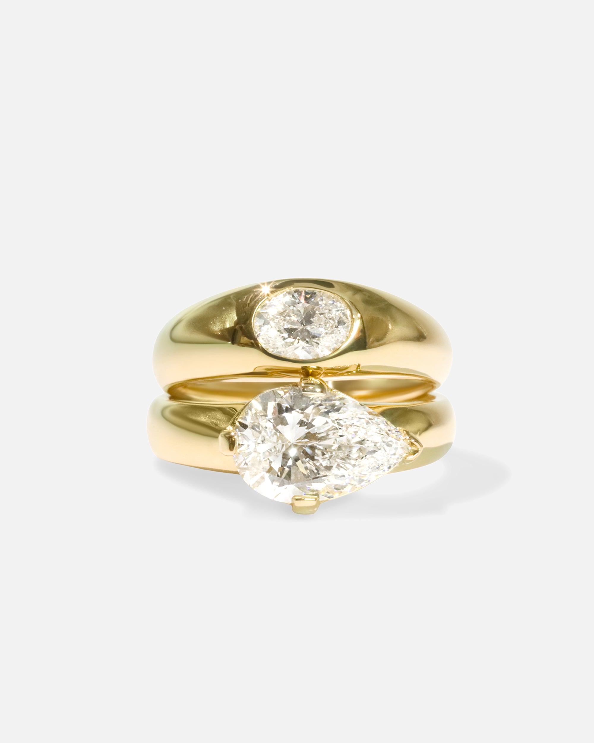 Group fully stacked view of Optic Oval Signet Ring / Diamond in 14k yellow gold and Comet Ring / Lab Pear Diamond in 14k yellow gold by Joko
