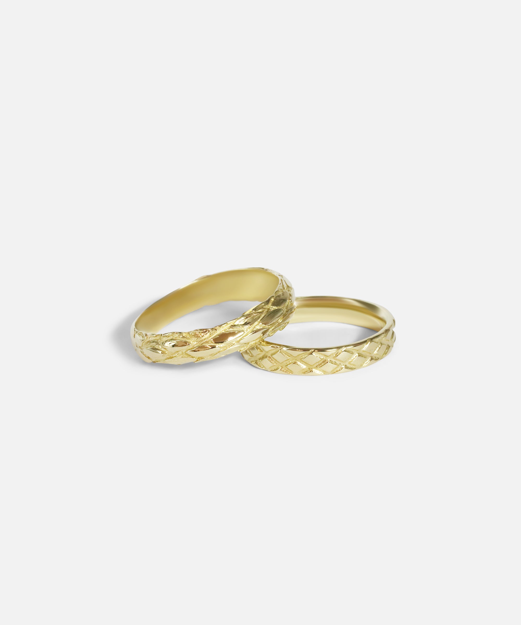 Stacked group shot of Scales Band in 14k yellow gold and Harlequin Band in 14k yellow gold by Ides