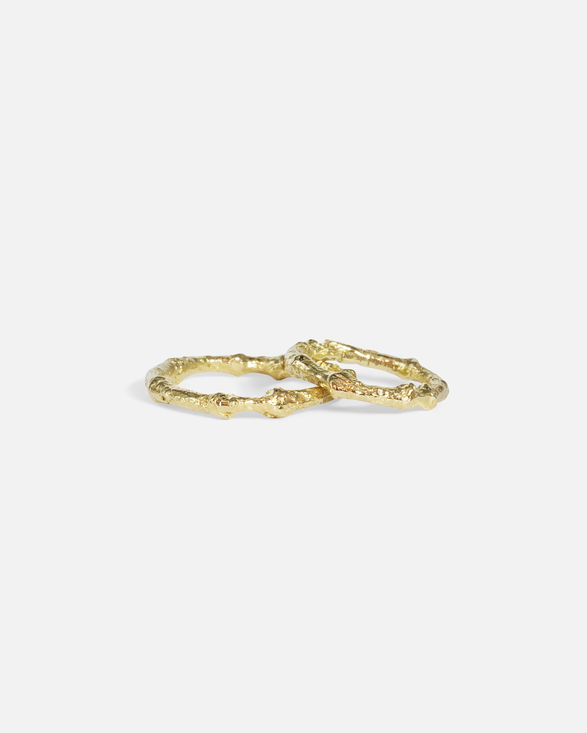 Stacked group shot of Bone Tree Band / Small and Bone Tree Band / Large in 14k yellow gold by Ides